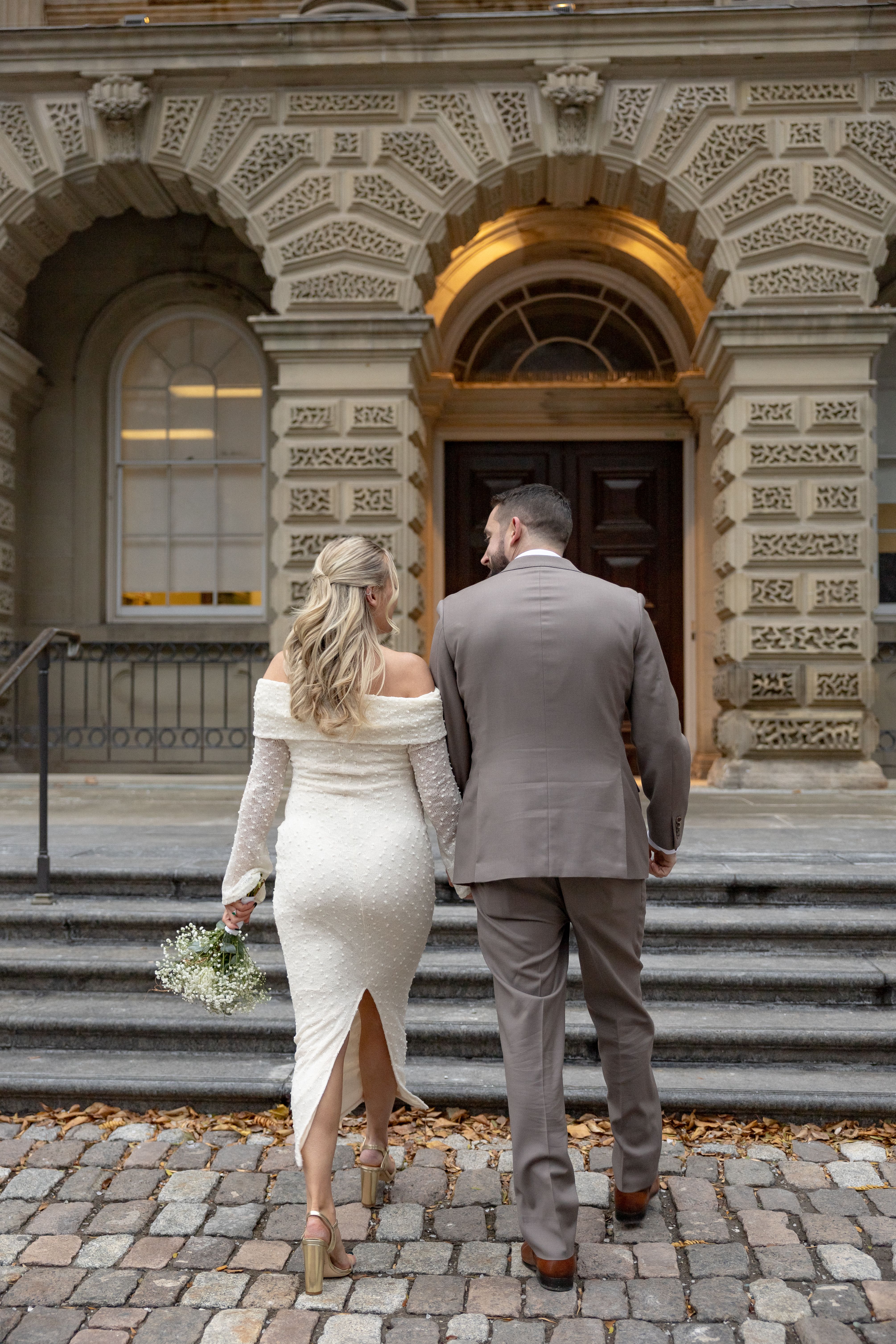 couple taking photos at osgoode hall before toronto city hall wedding