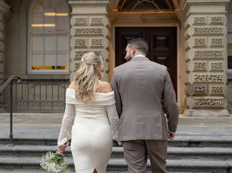couple taking photos at osgoode hall before toronto city hall wedding
