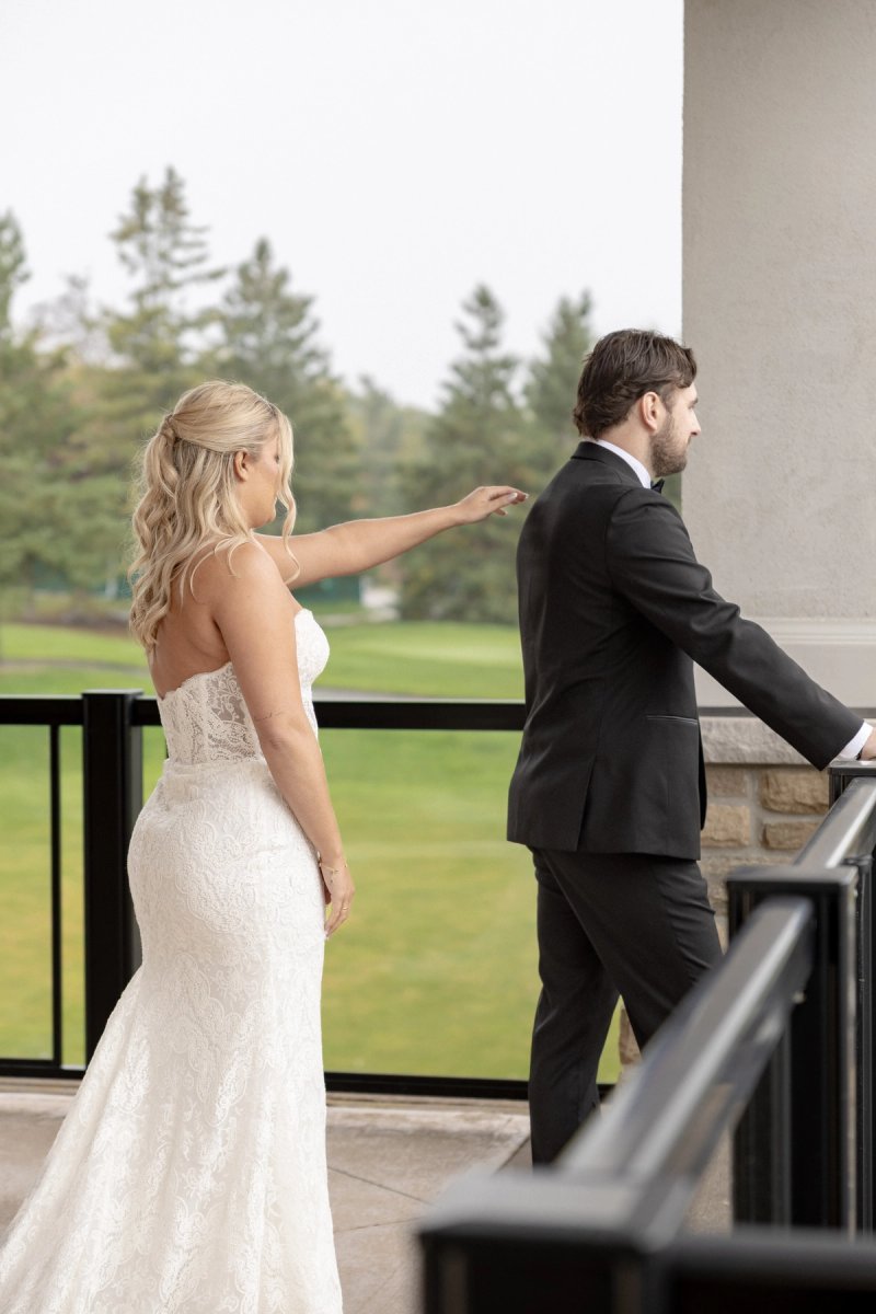 bride and groom on balcony of barrie country club wedding first look