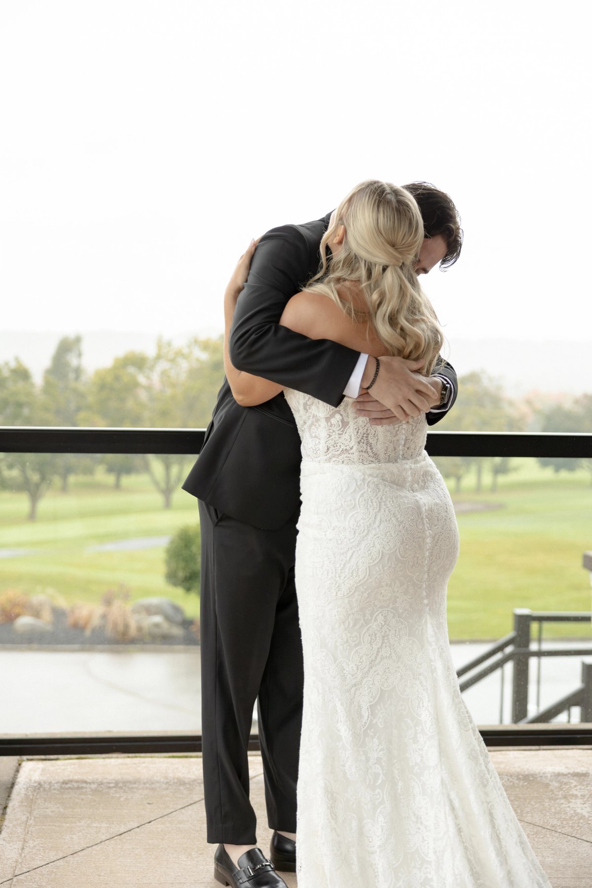 Barrie Country Club Wedding first look on balcony hugging