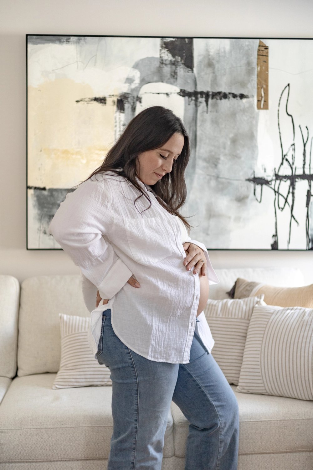 Pregnant woman posing in front of abstract art - Newmarket Maternity Photography 