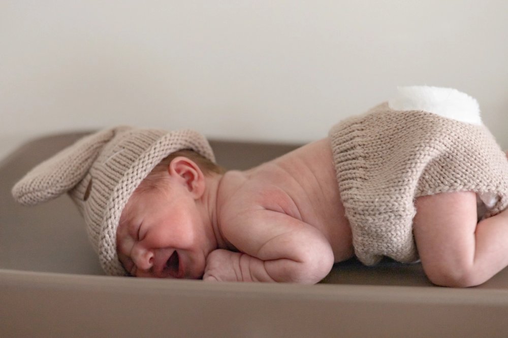newborn baby with knitted bunny hat and diaper - Newborn Photography