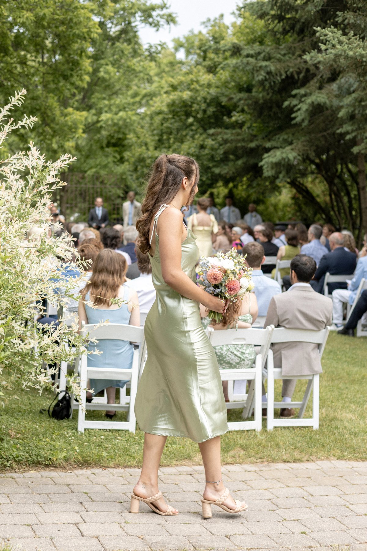 Bridesmaid walking during Wedding ceremony at Kurtz Orchards Niagara-on-the-Lake