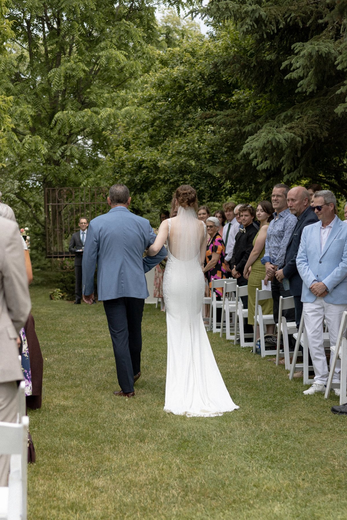 bride and father walking down the aisle of outdoor wedding ceremony at Kurtz Orchards in Niagara-on-the-Lake