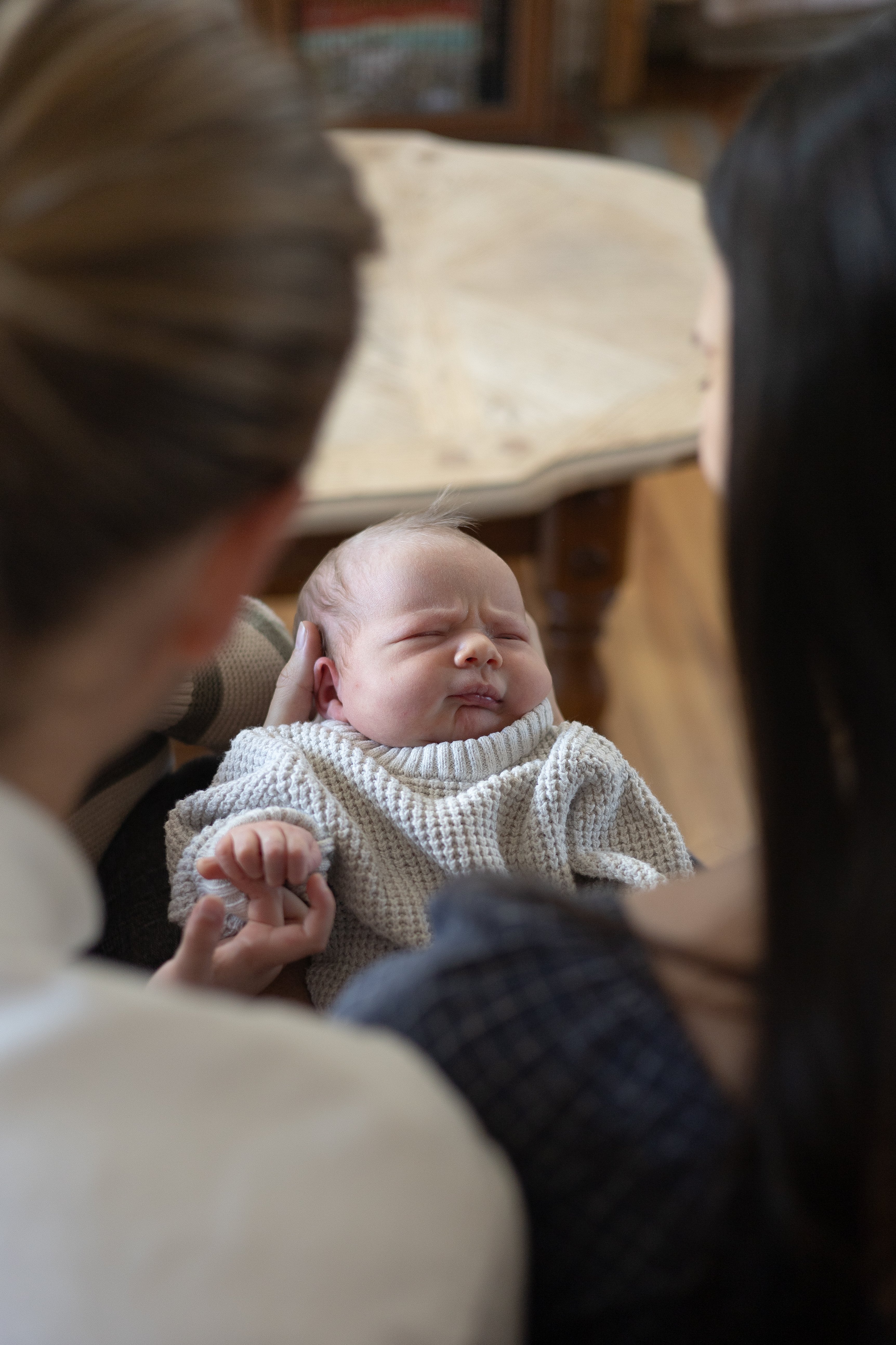 View of newborn baby from behind parents | Newmarket Newborn Photographer