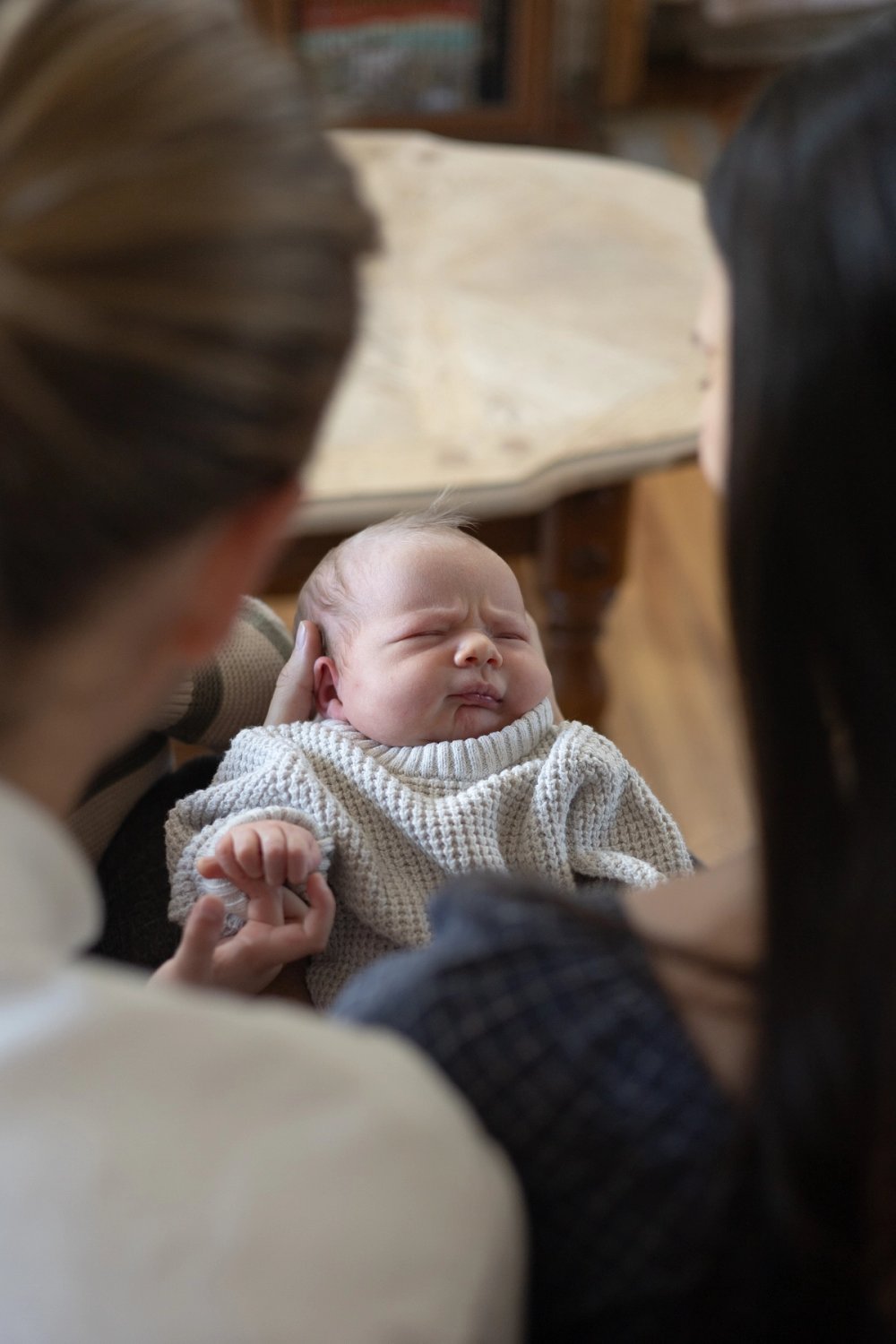 View of newborn baby from behind parents | Newmarket Newborn Photographer