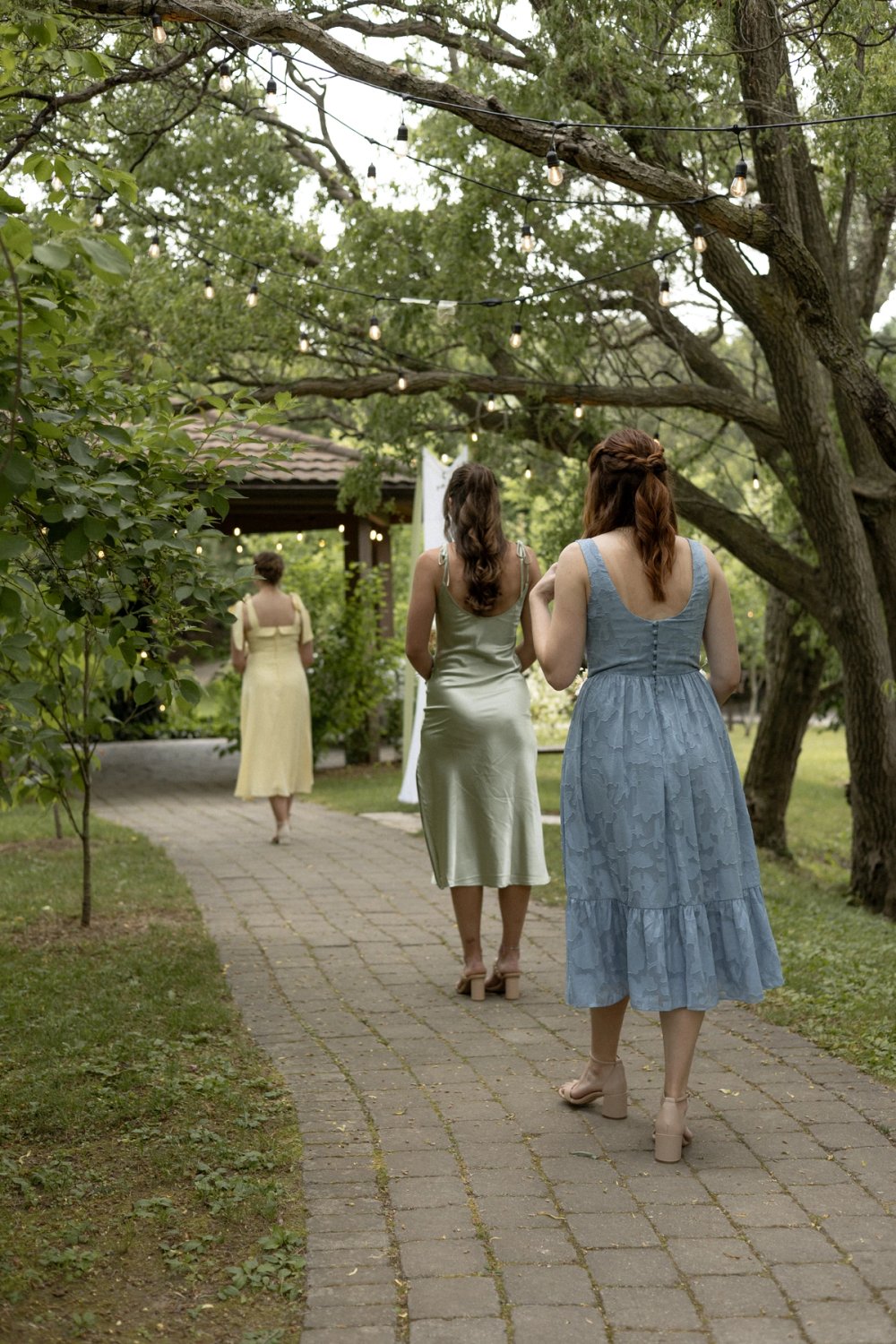Bridal party holding pastel floral bouquets