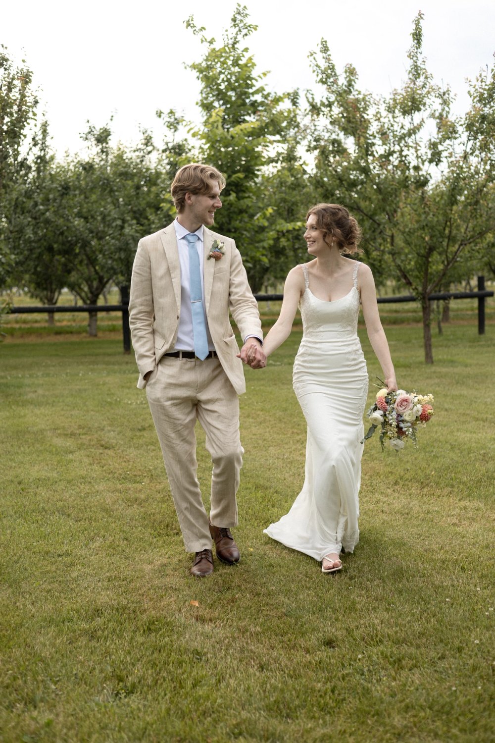 Bride and groom walking together at end of wedding night