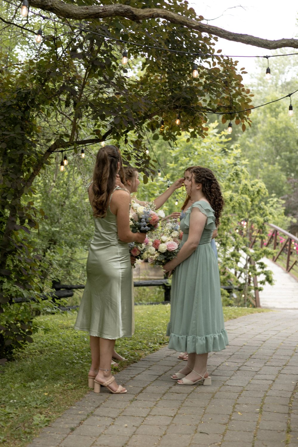 Bridesmaids wearing pastel summer dresses at Kurtz Orchards wedding