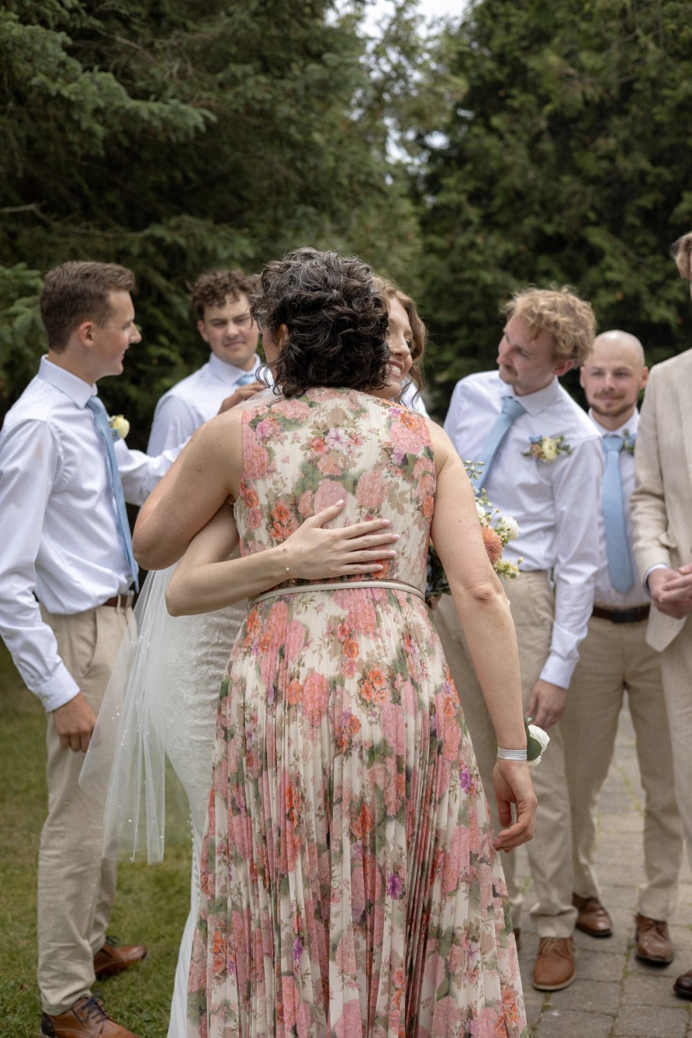 Bride hugging mother-in-law after outdoor wedding ceremony in Niagara-on-the-Lake