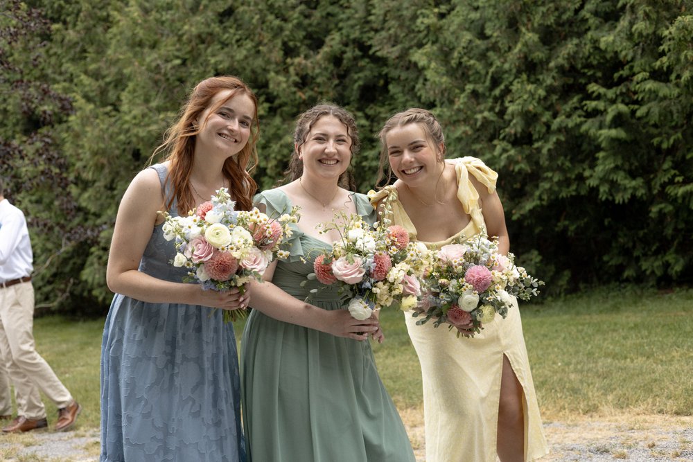 Candid moment of bridesmaids smiling while waiting for bridal portraits