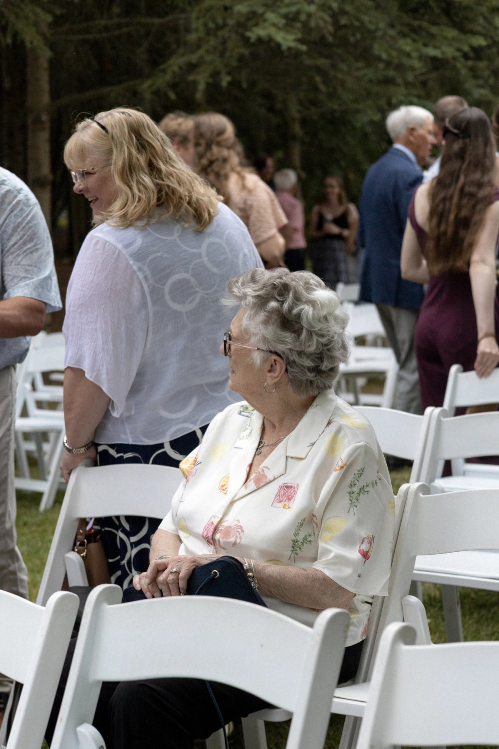 Elderly guest seated after outdoor wedding ceremony in Niagara