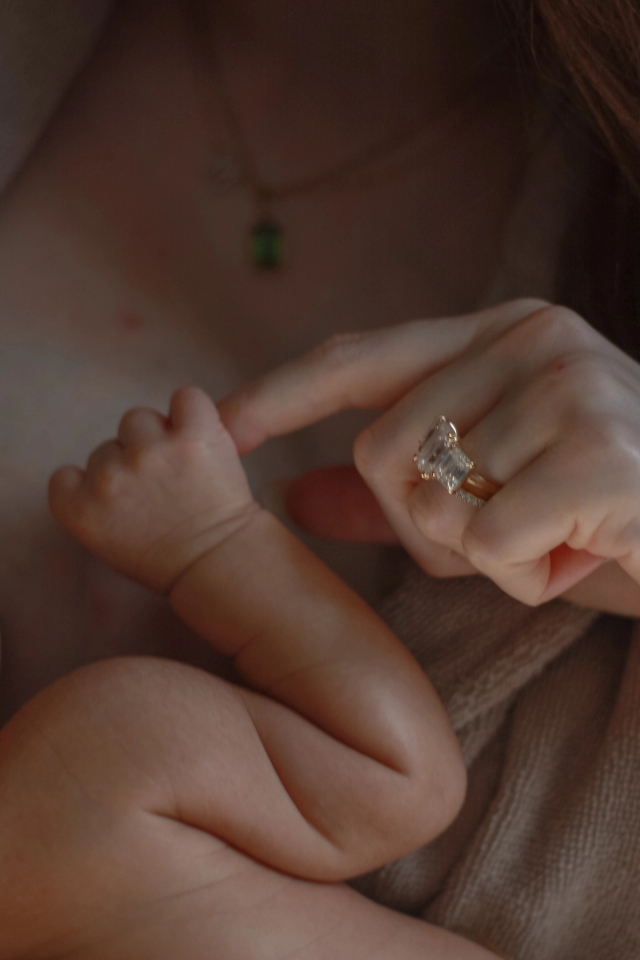 close up of newborn baby grasping mom's finger - newborn photography