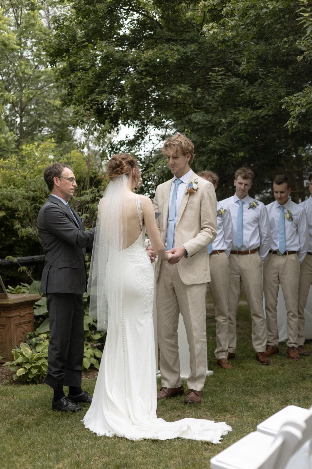 Couple exchanging vows during outdoor wedding ceremony