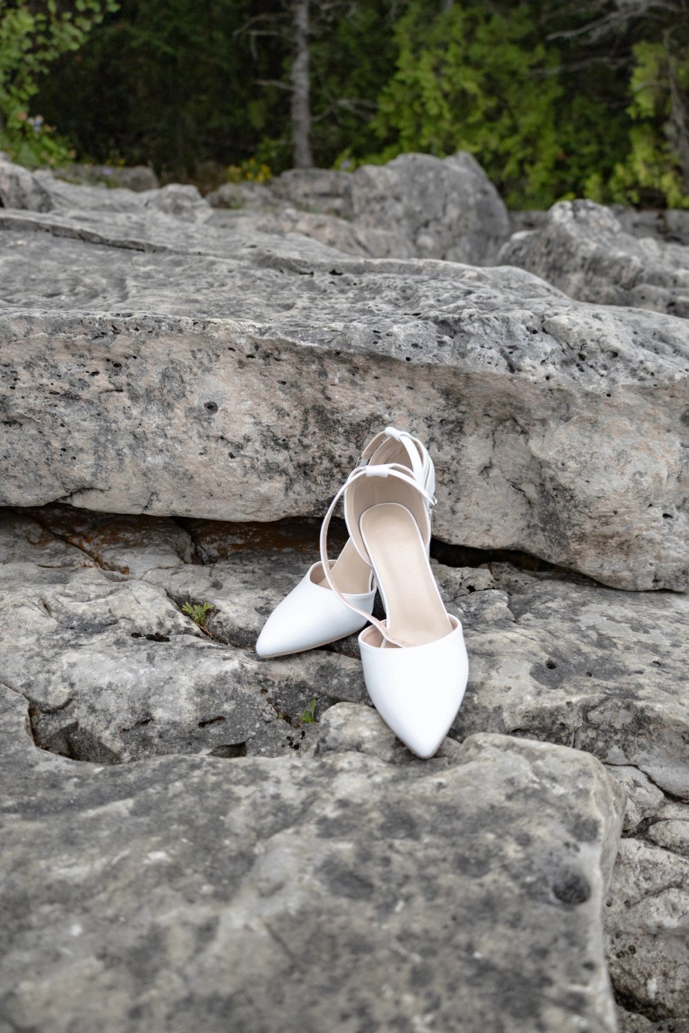 bride's wedding shoes sitting on rocks during Tobermory Elopement Ceremony
