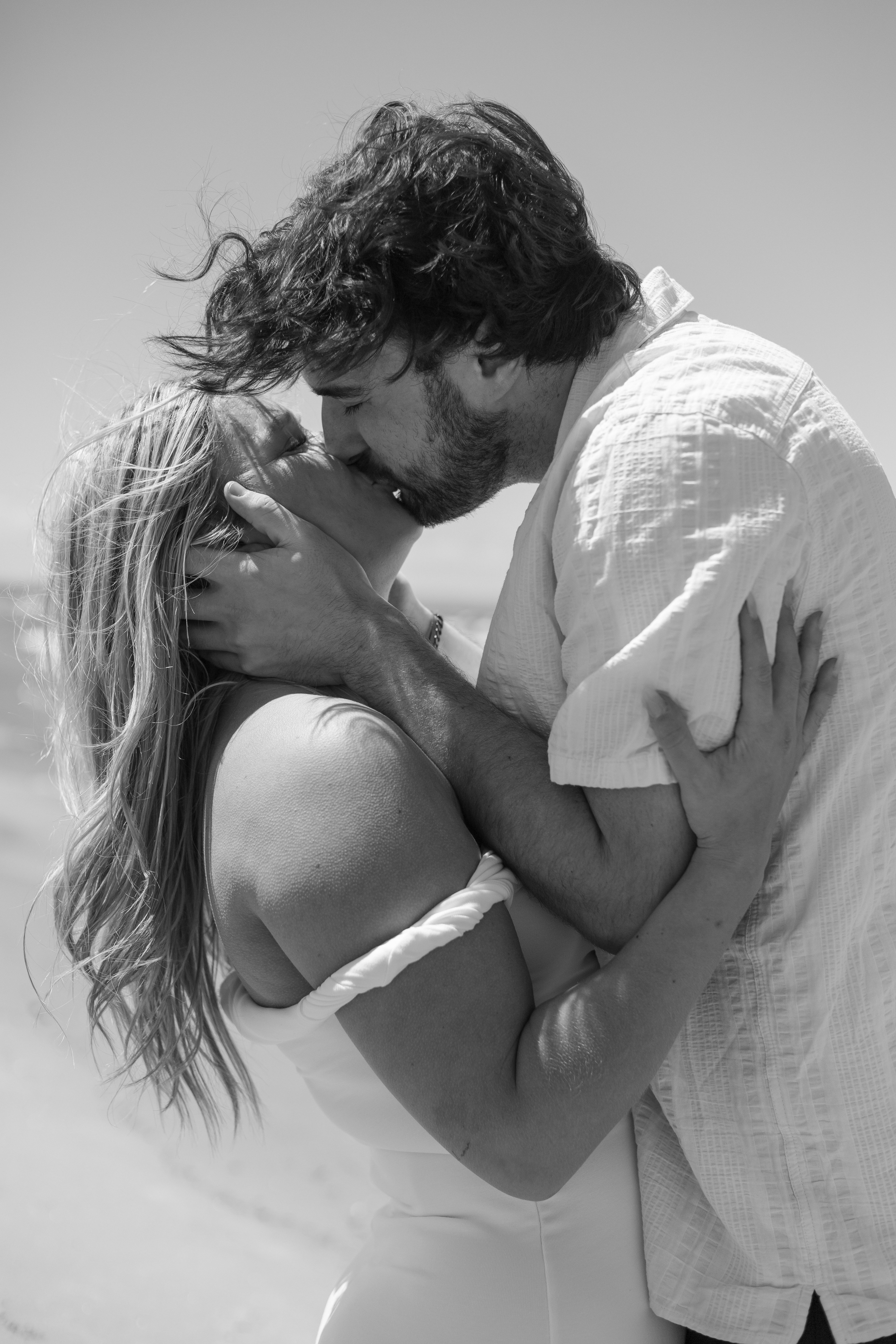 man and woman kissing passionately on the beach - Wasaga Beach Engagement Photography