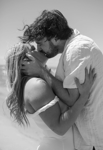 man and woman kissing passionately on the beach during engagement photos at Wasaga Beach, Ontario