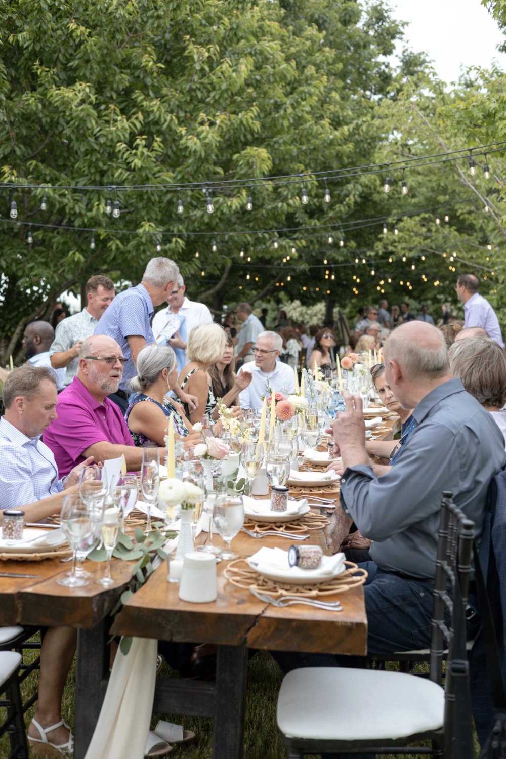 Wedding guests chatting during outdoor summer reception