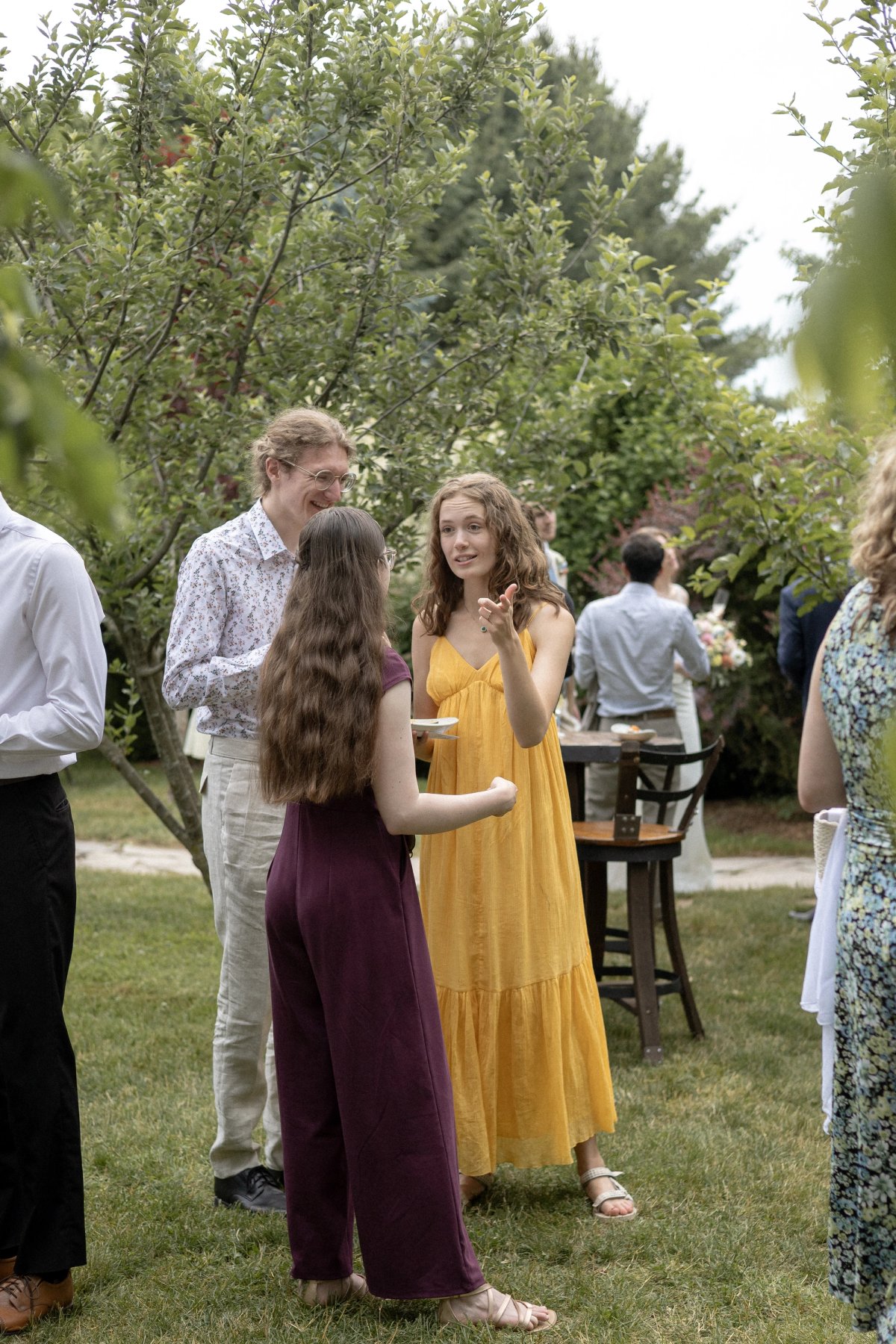 Friends celebrating during orchard wedding