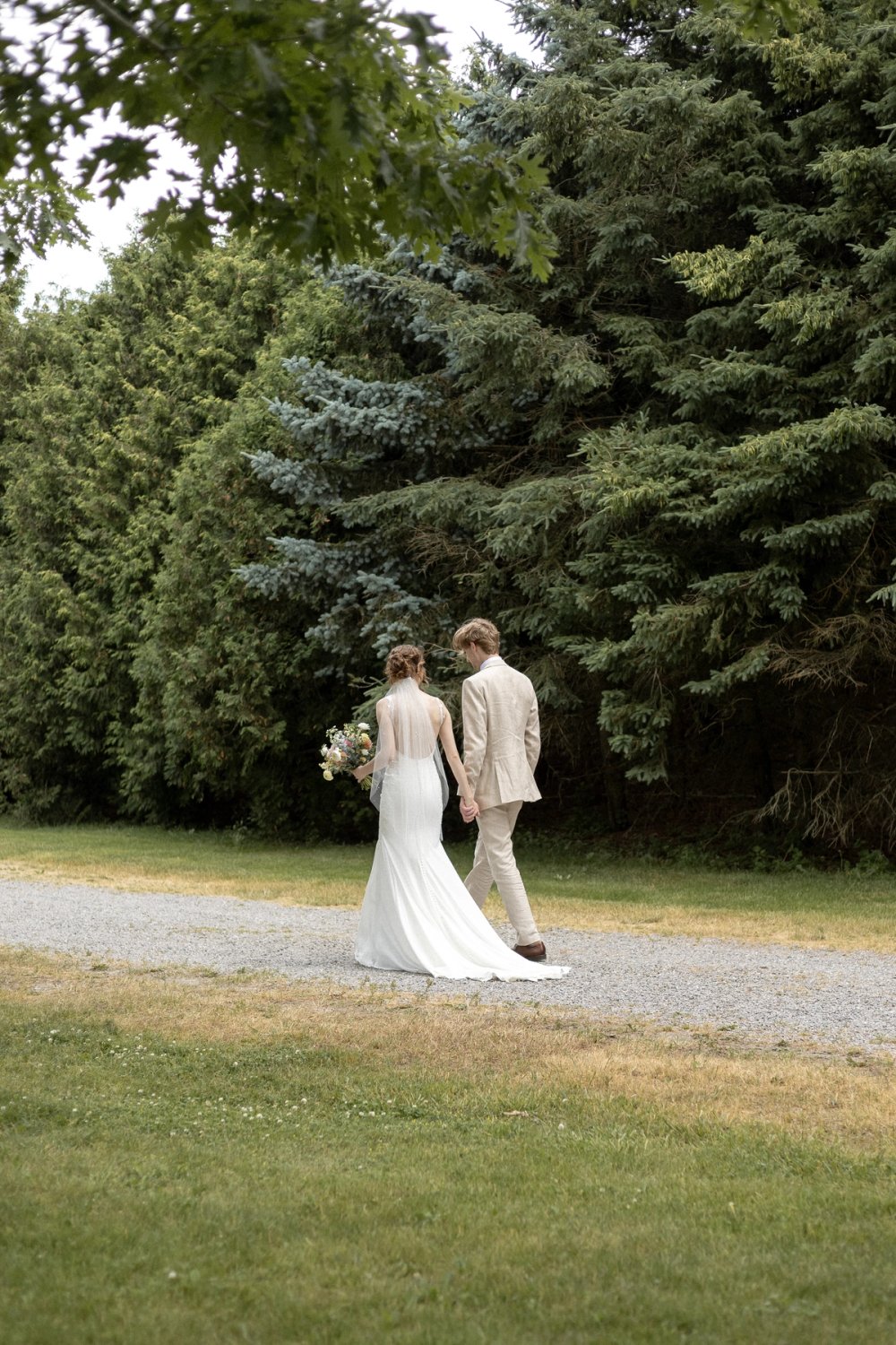 Couple walking along gravel path at Kurtz Orchards after first look