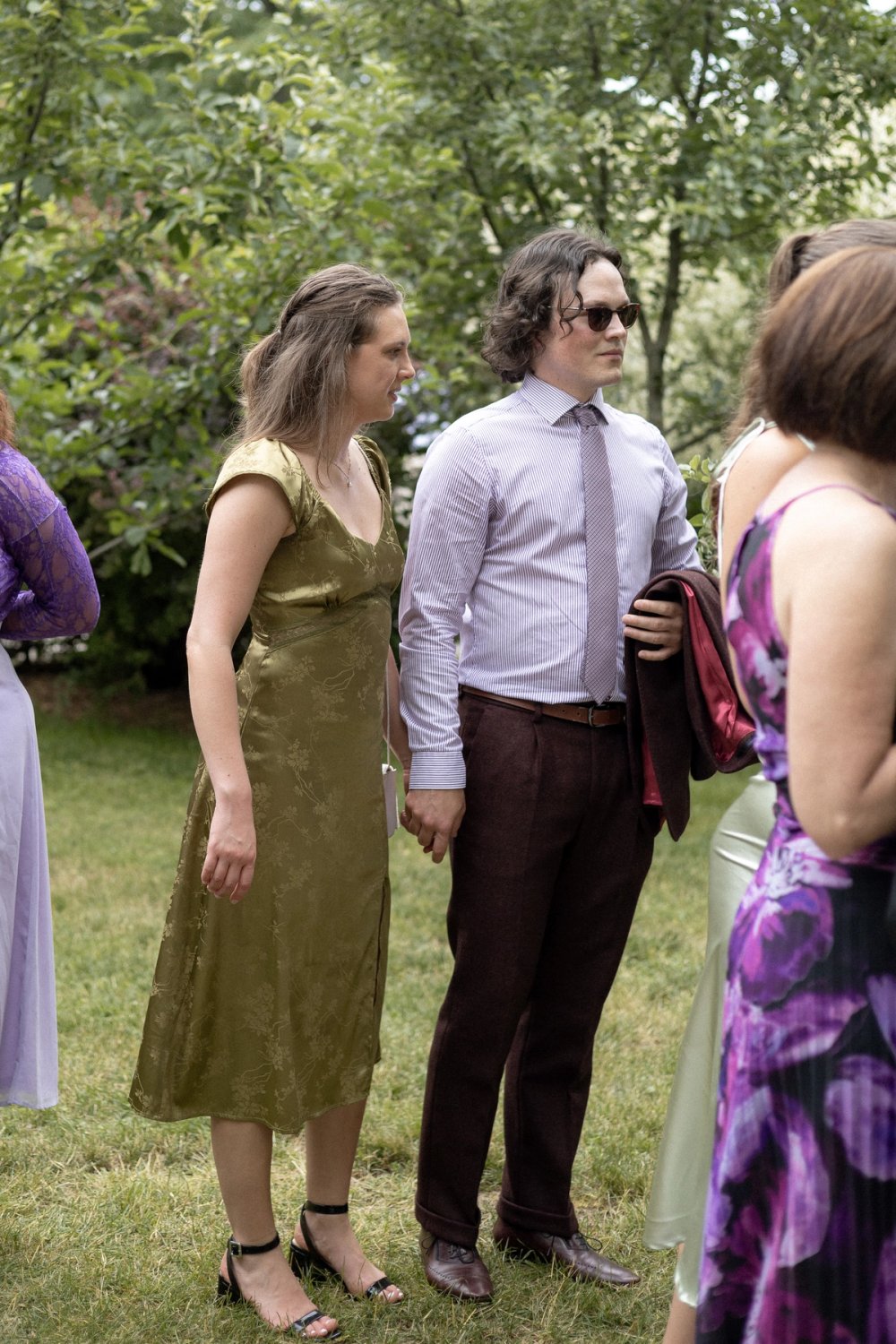 Guests amongst orchards during cocktail reception summer wedding