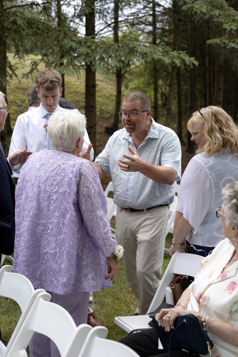 Elderly guests laughing together after outdoor wedding ceremony