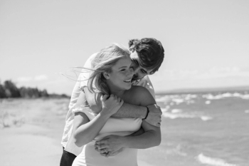 man's arm around woman by the beach - Tobermory Elopement Photography