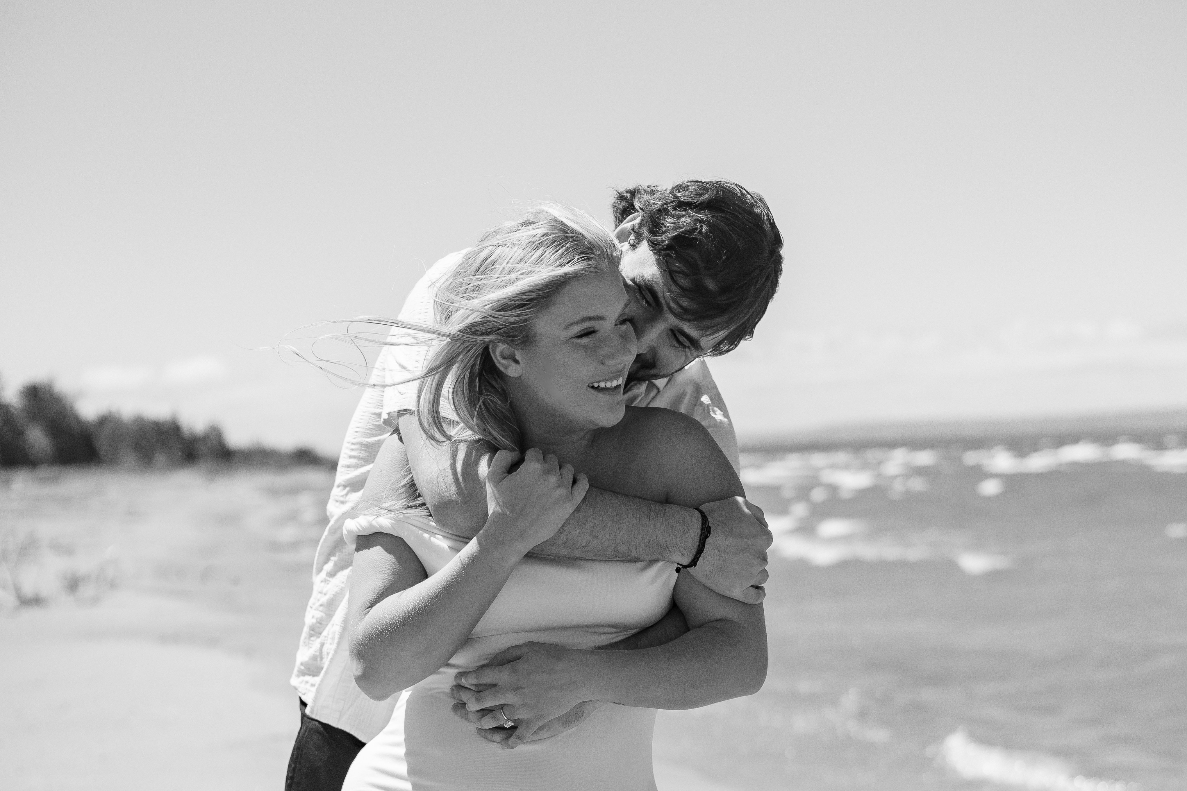 man's arm around woman by the beach - Tobermory Elopement Photography