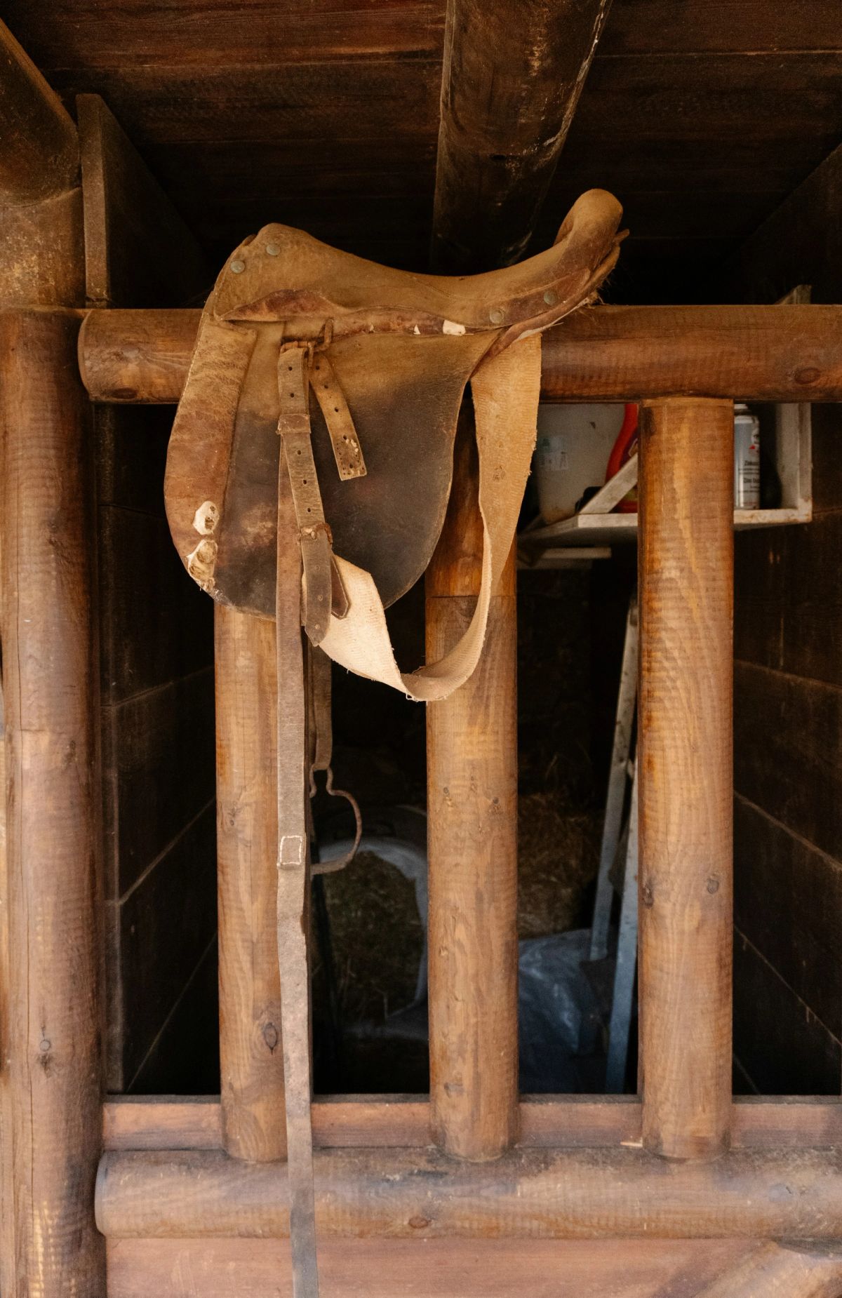 An old saddle on wooden beams