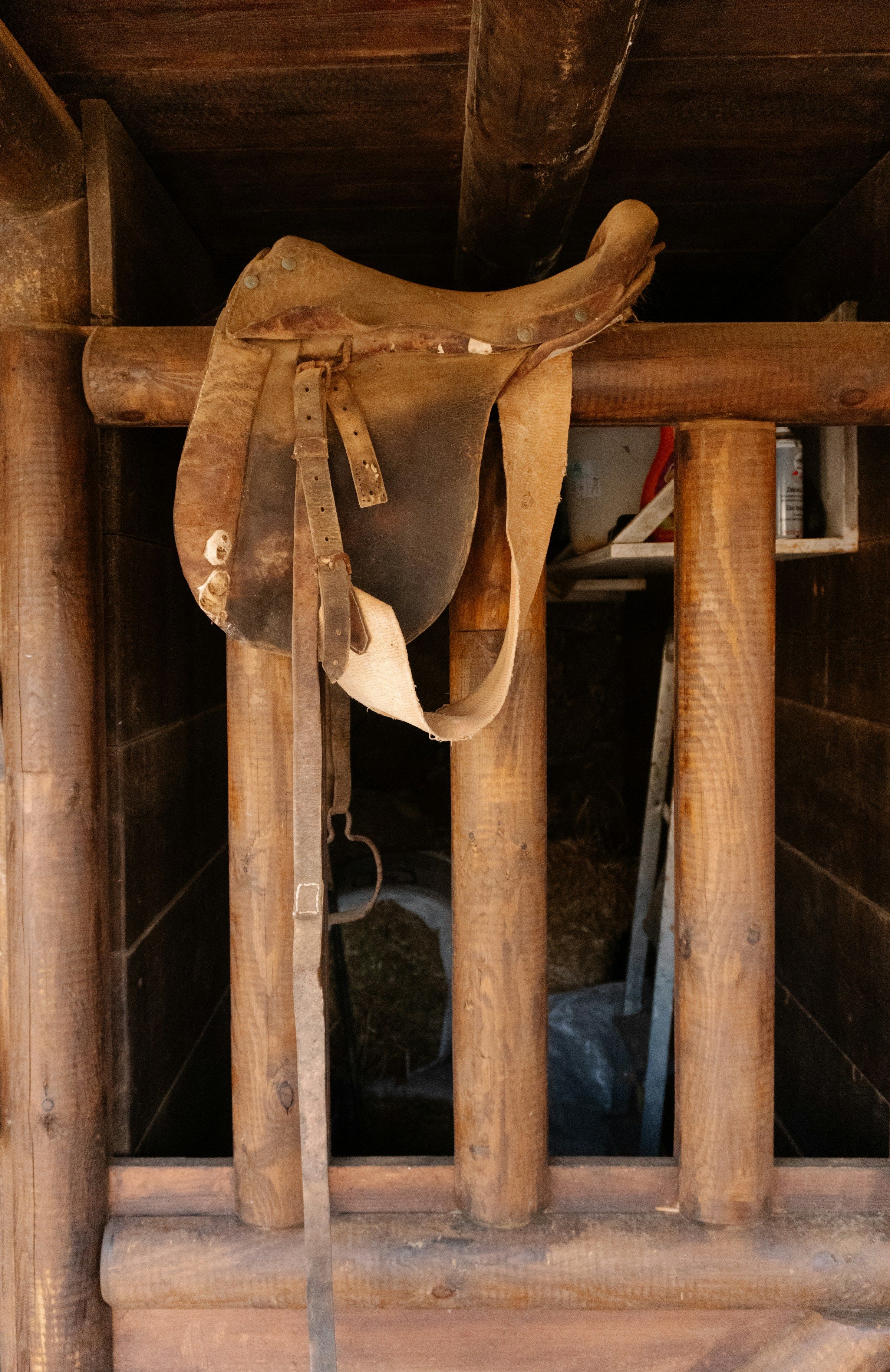 An old saddle on wooden beams