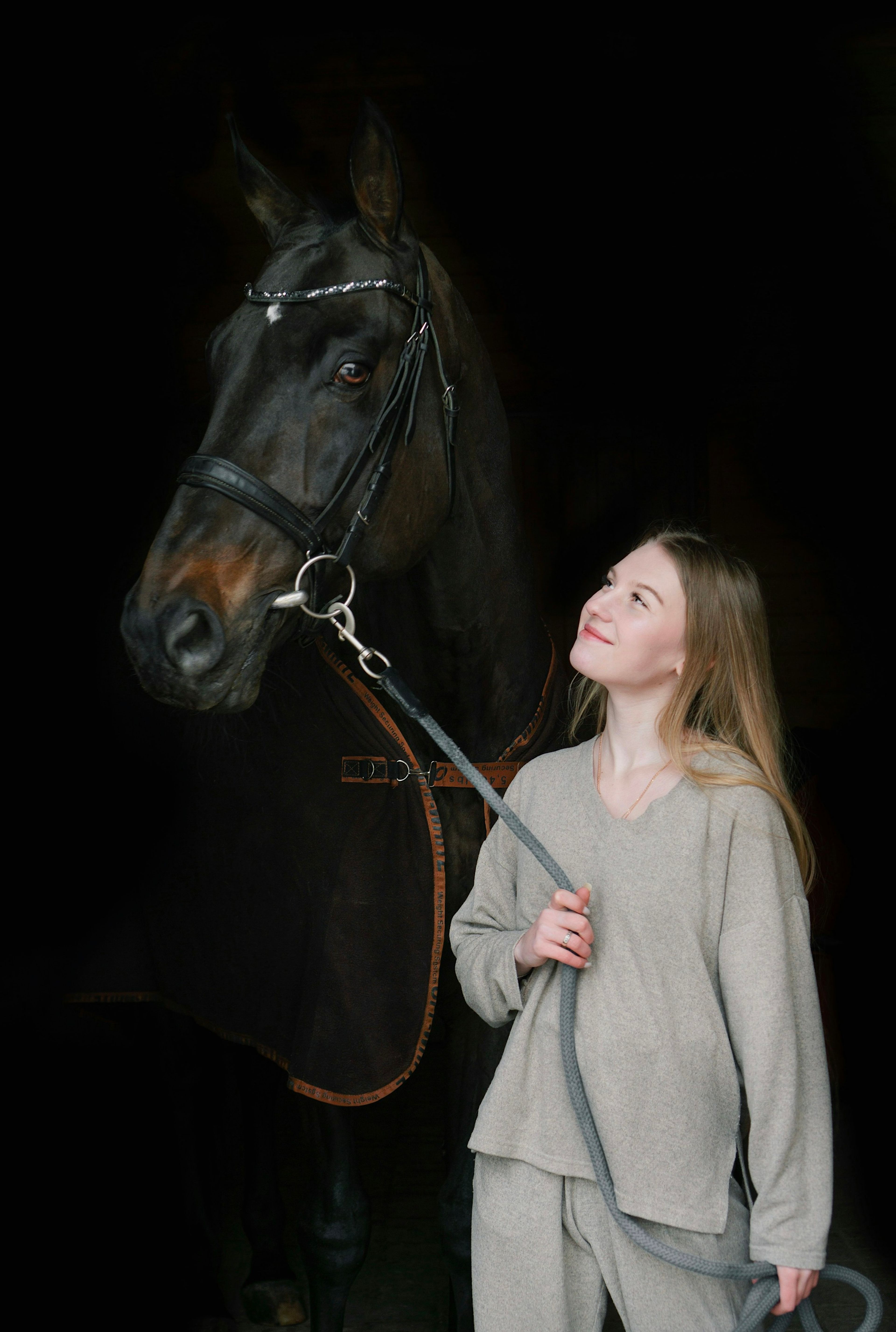 Hélène Duroc standing beside a black horse