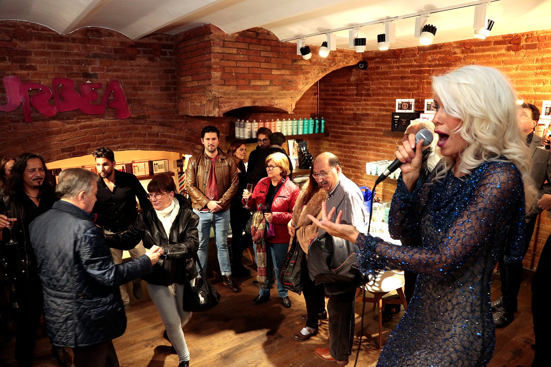 Singer performing among guests indoors