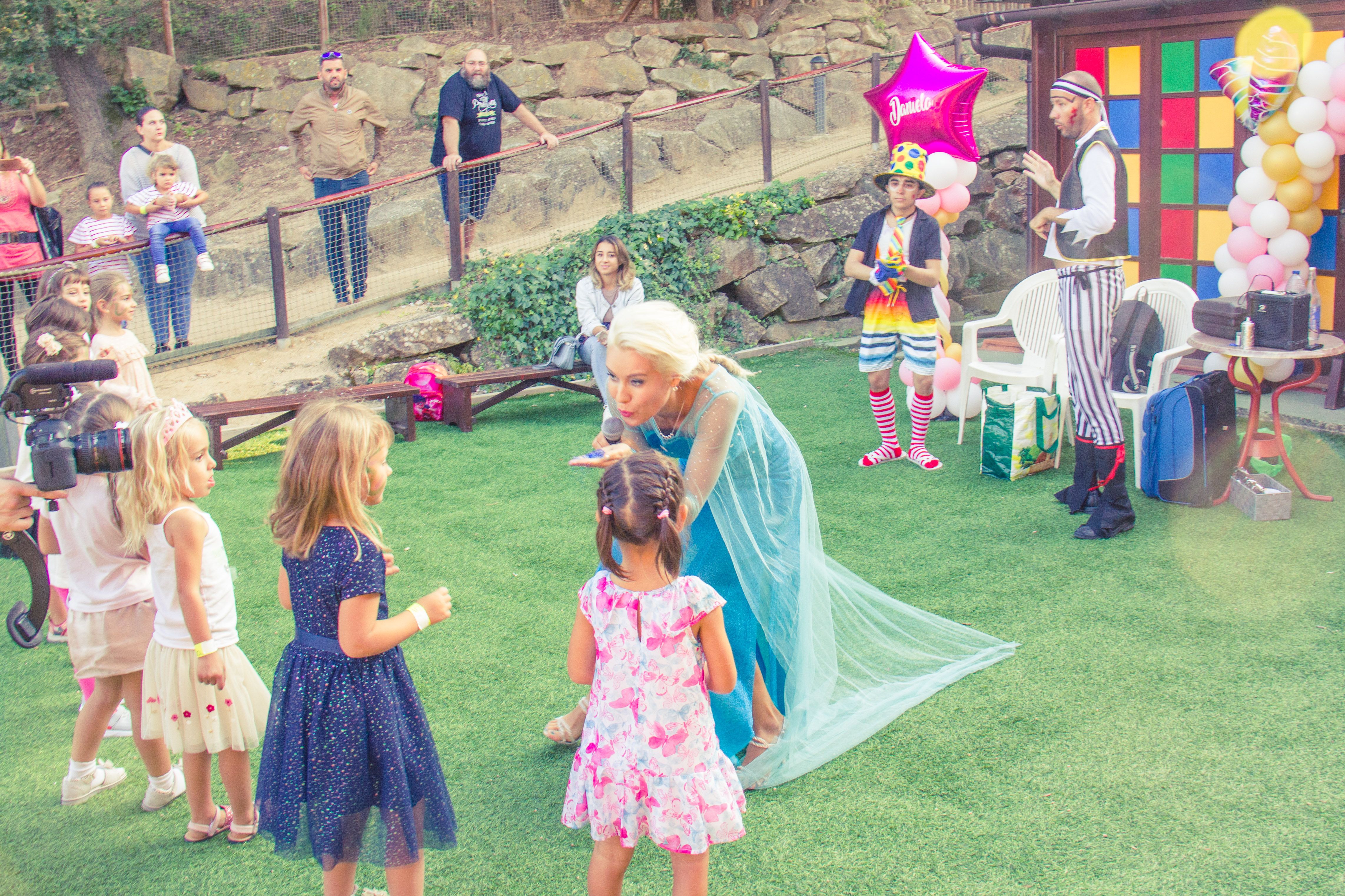 Costumed performer interacting with children outdoors