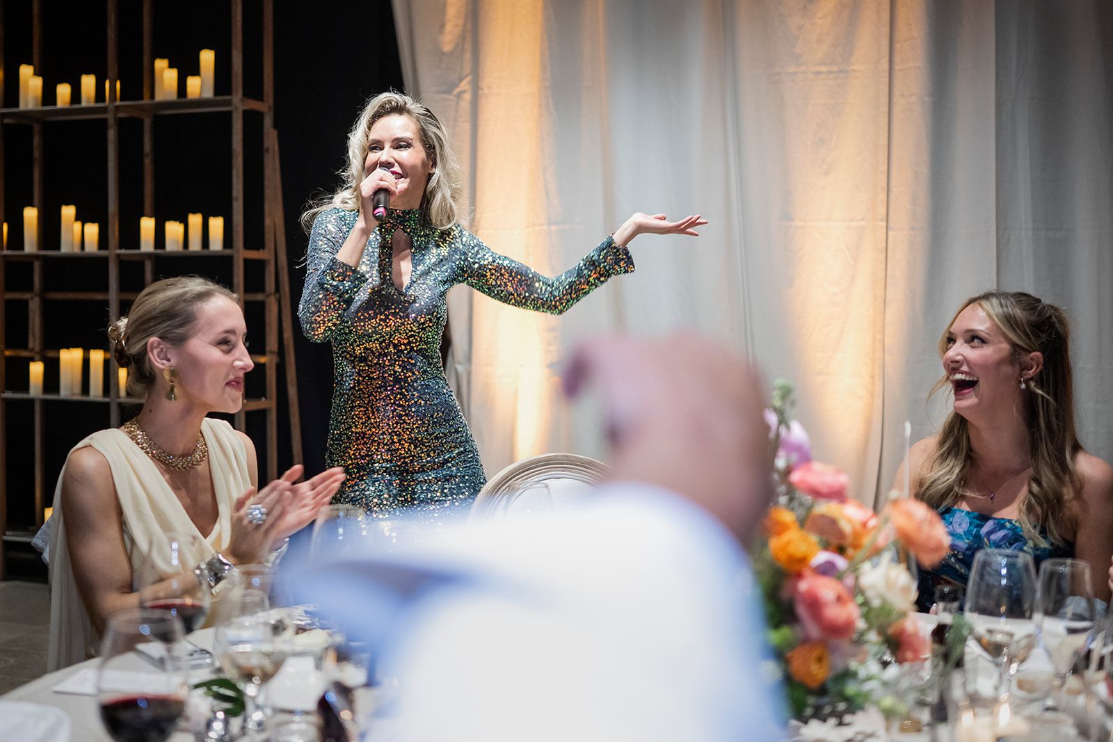 Singer performing among guests seated at tables