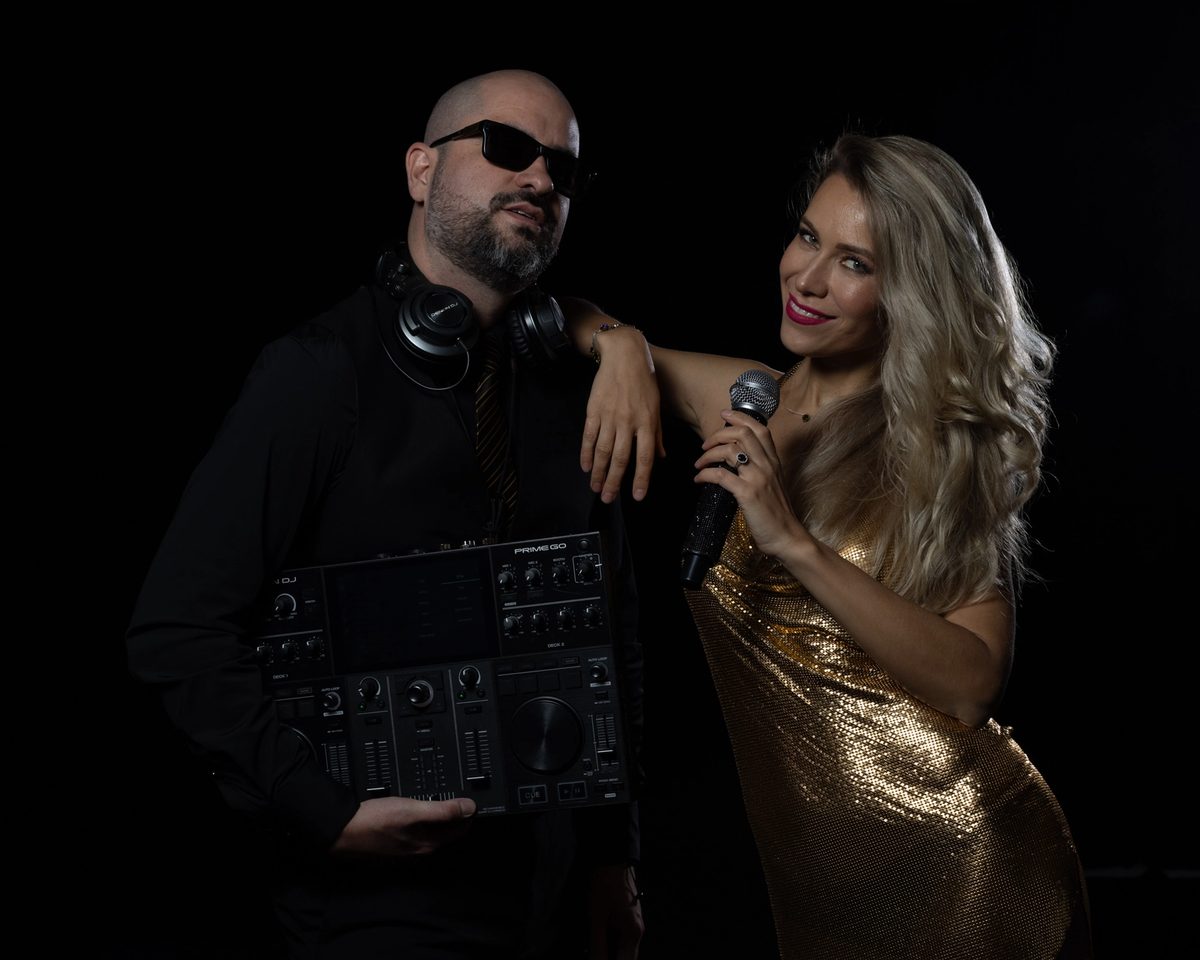 A singer beside a DJ with a mixing console