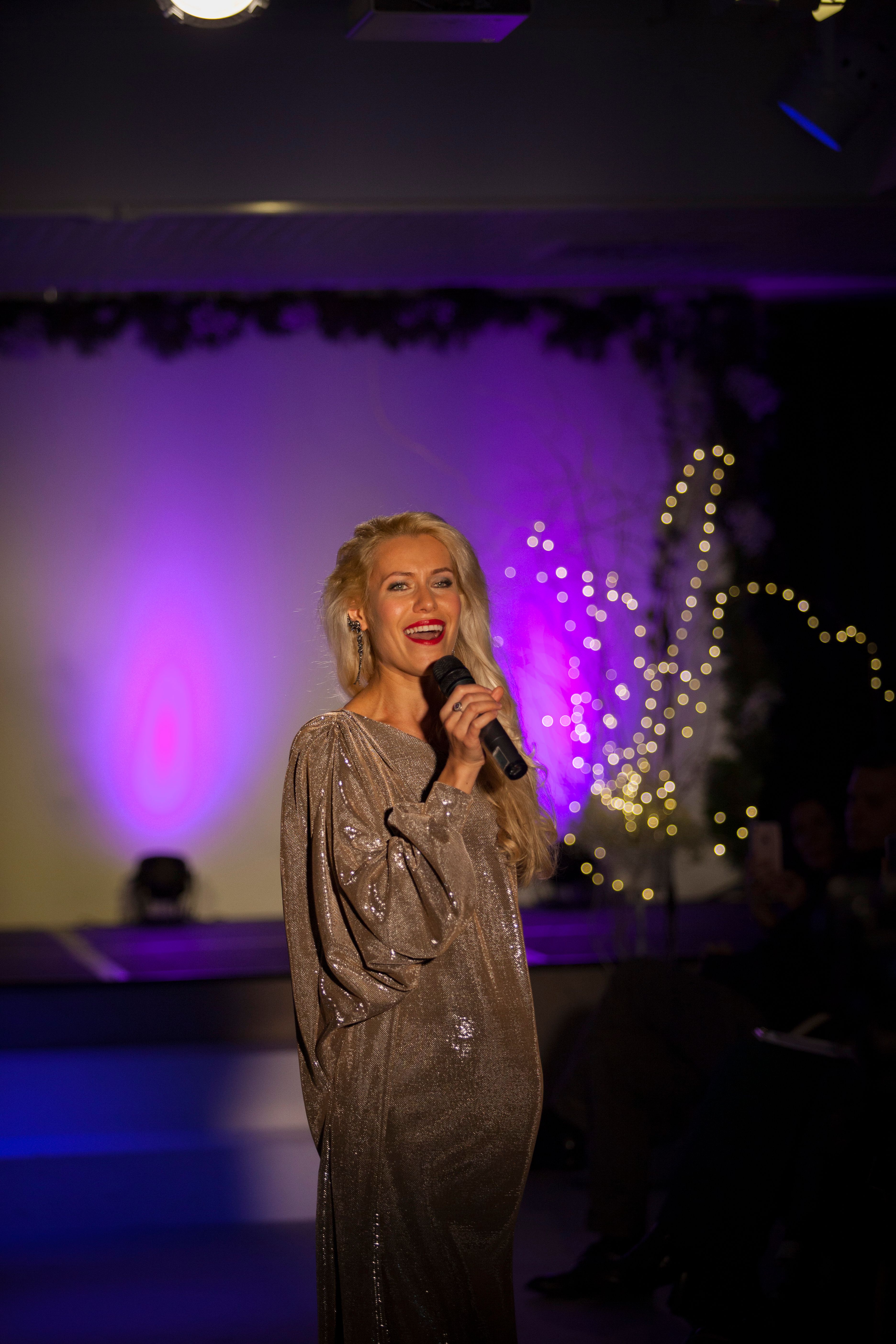 Singer performing on an illuminated stage
