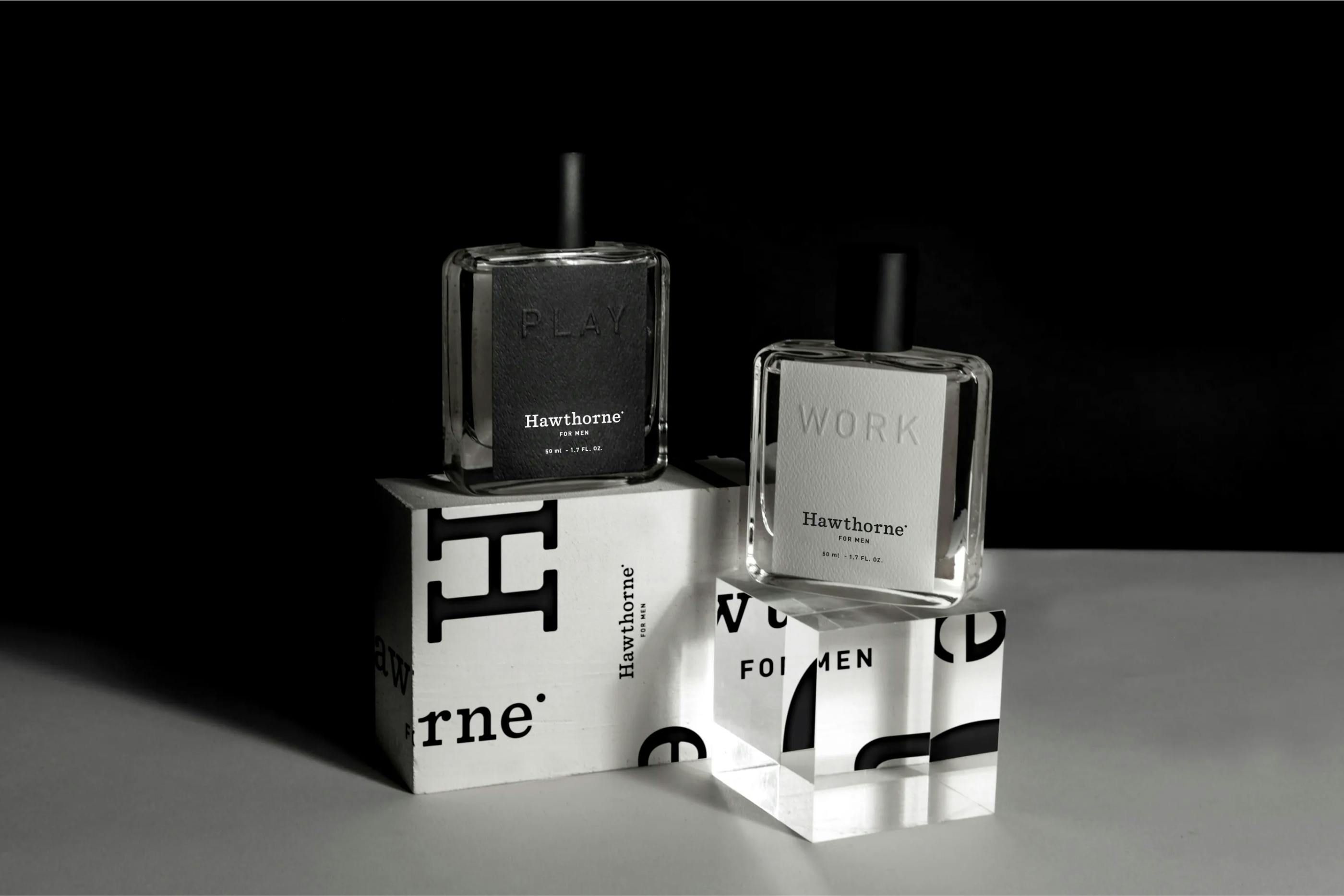 2 bottles of Hawthorne perfume sitting against a dark background