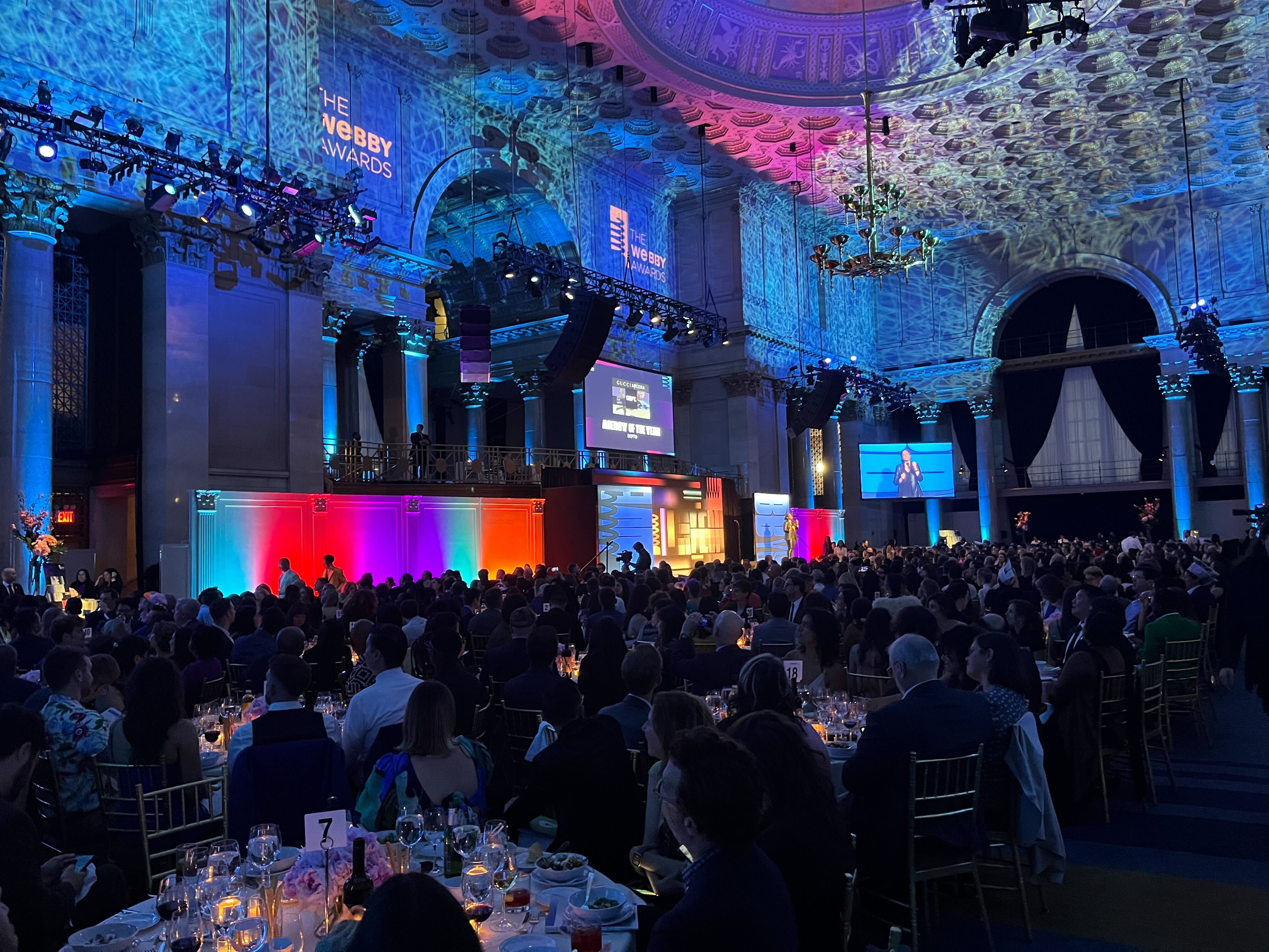 Photo captured during the Webby Award Ceremony in NYC showing the stage and dinner guests.