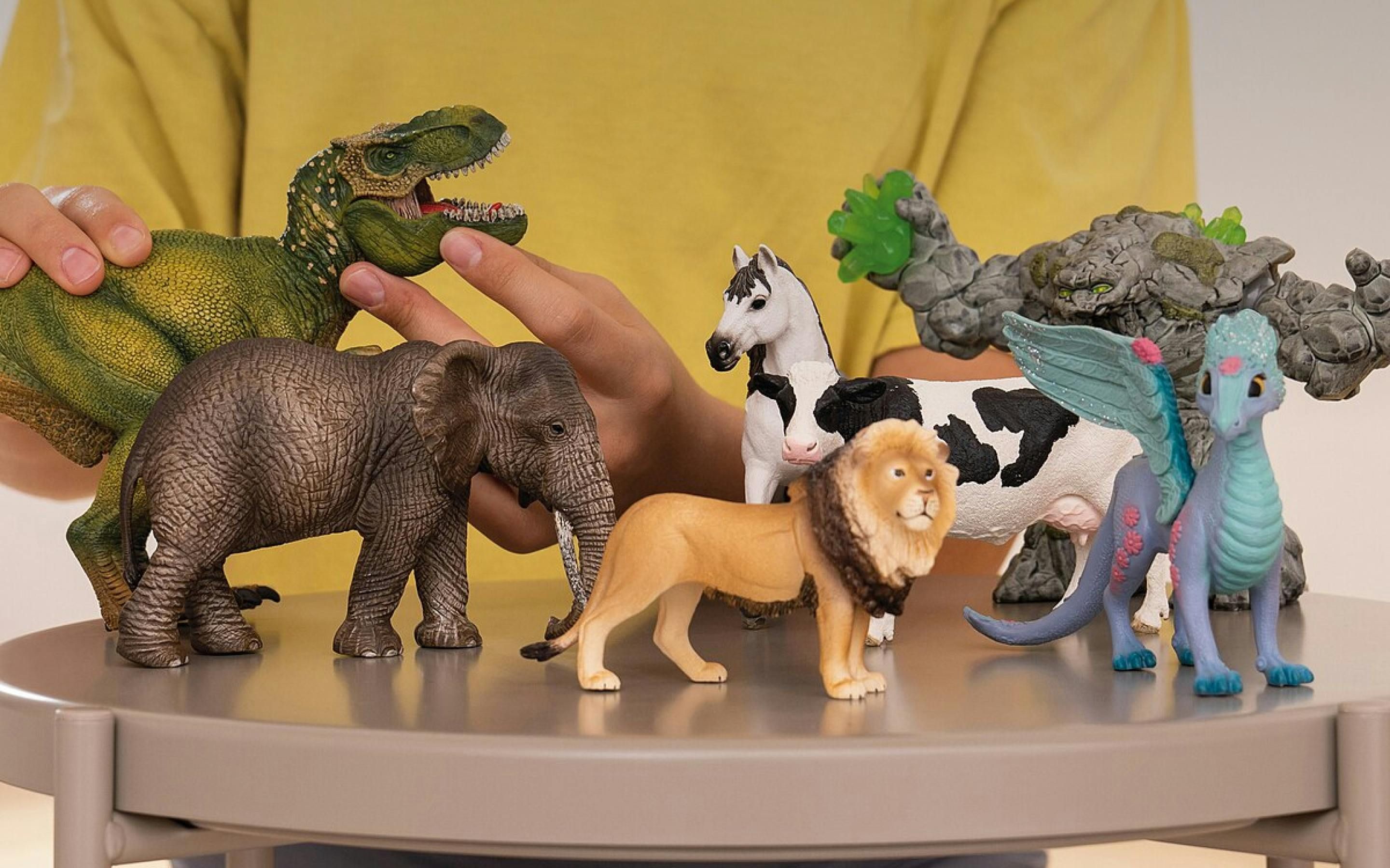 A child playing with various Schleich toys