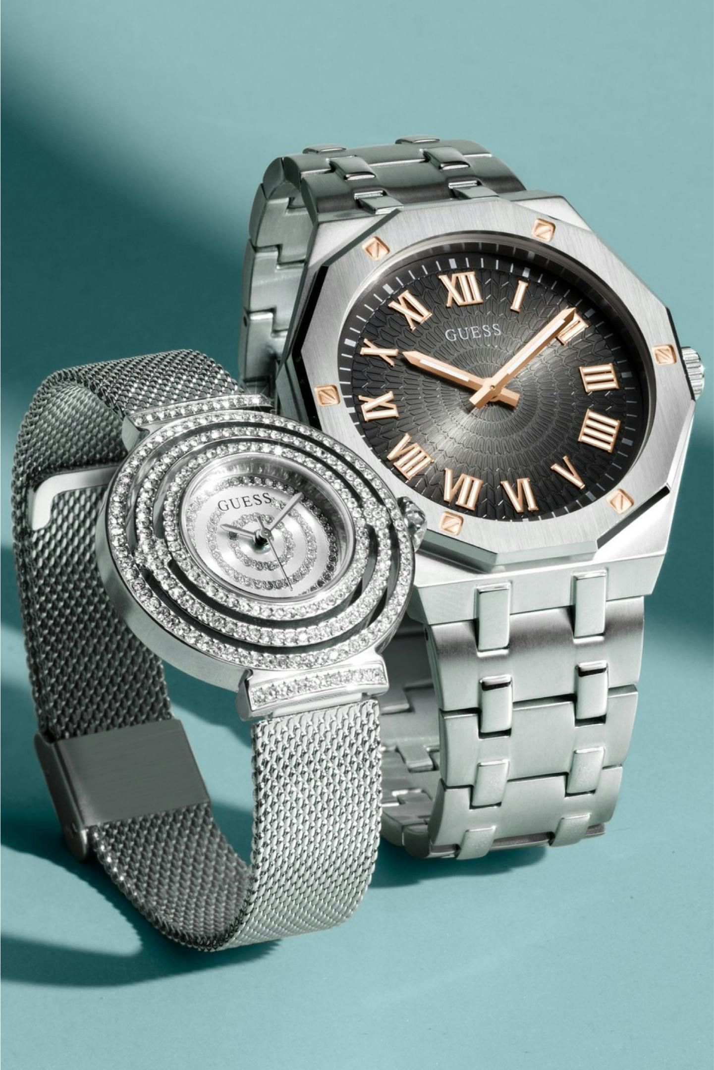 A women's and a men's Guess watch