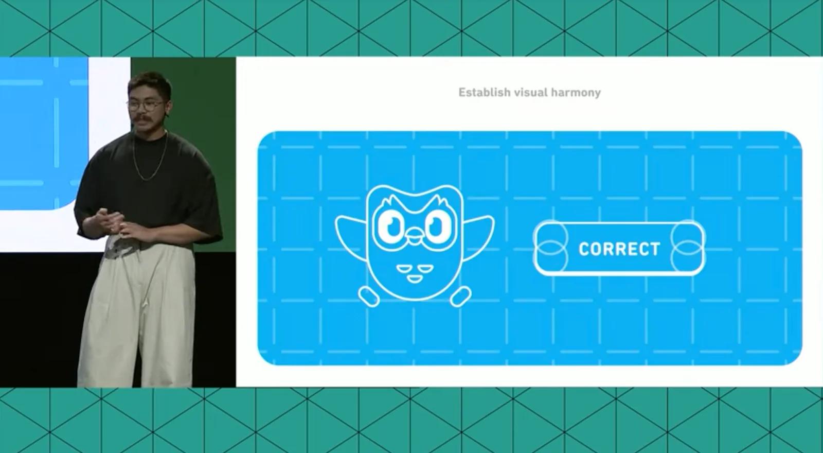 Speaker at Figma Config 2023 with a slide showing Duolingo's interface.