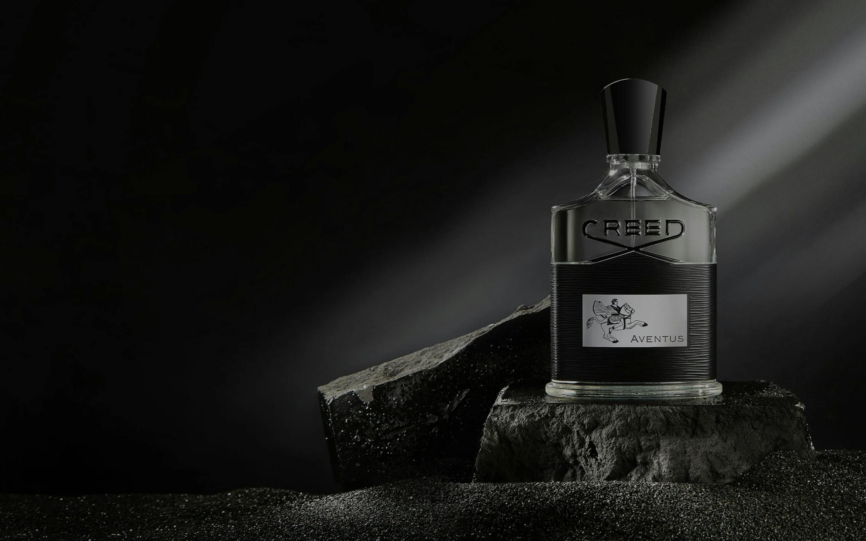 Hero photo of Creed Aventus fragrance sitting on a rock