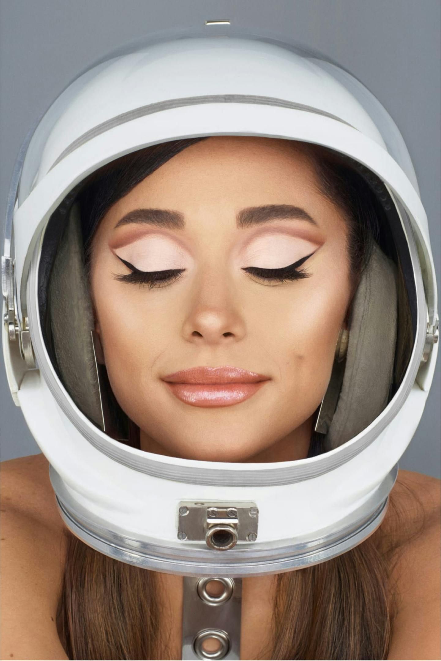 Ariana Grande wearing r.e.m. beauty products and a space helmet