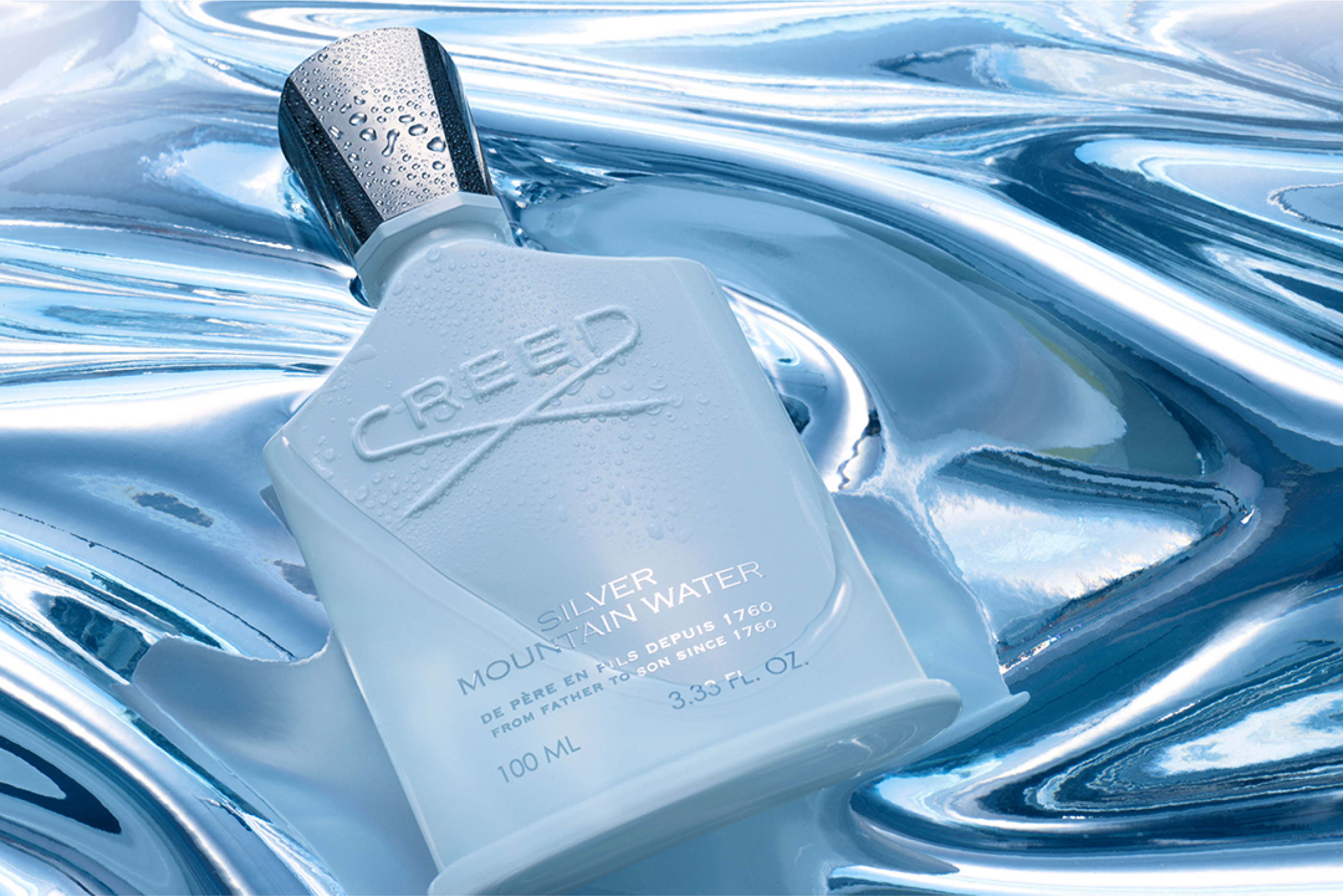 Silver Mountain Water fragrance from Creed sitting on a watery surface