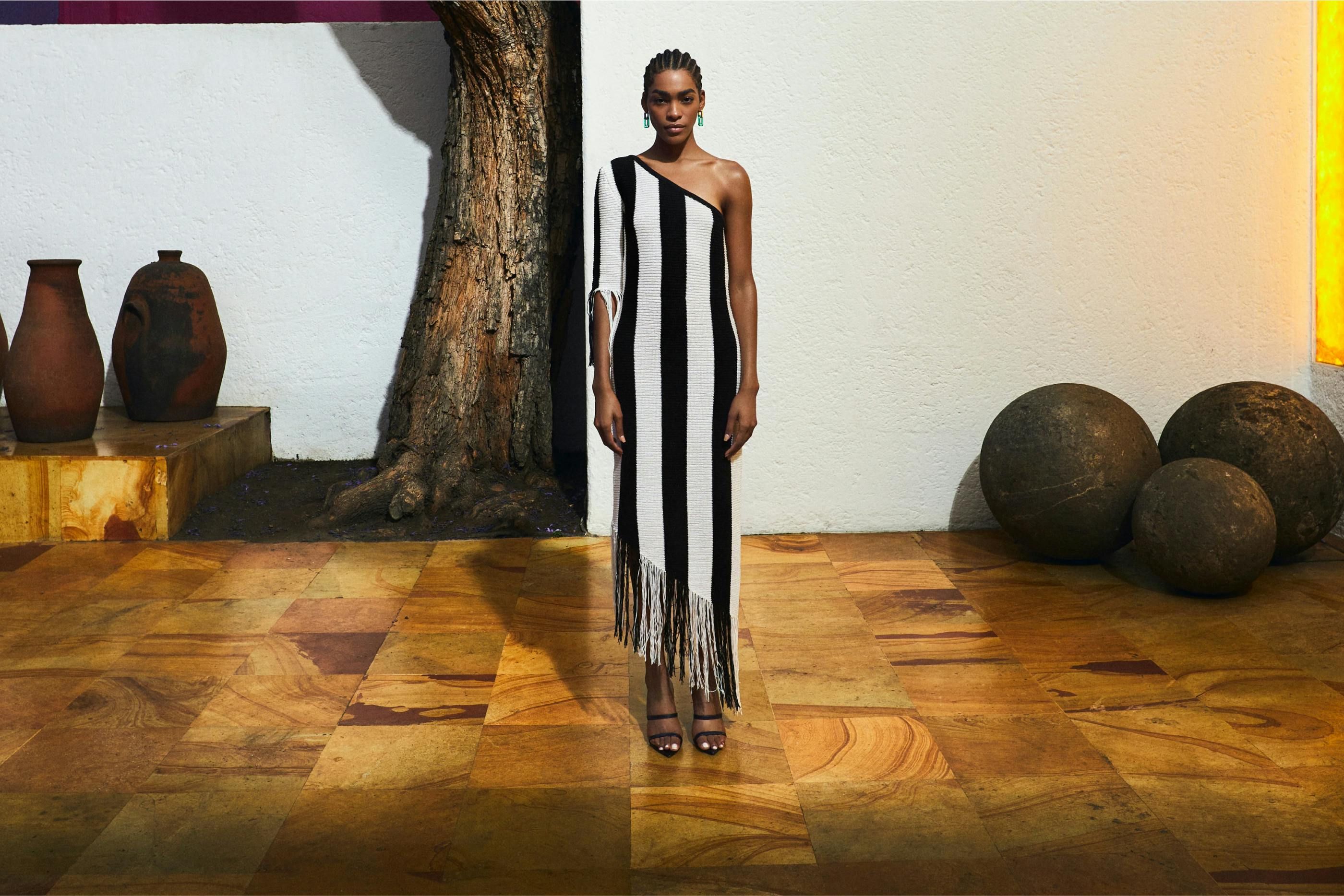 Model wearing BCBG dress standing on wooden floor