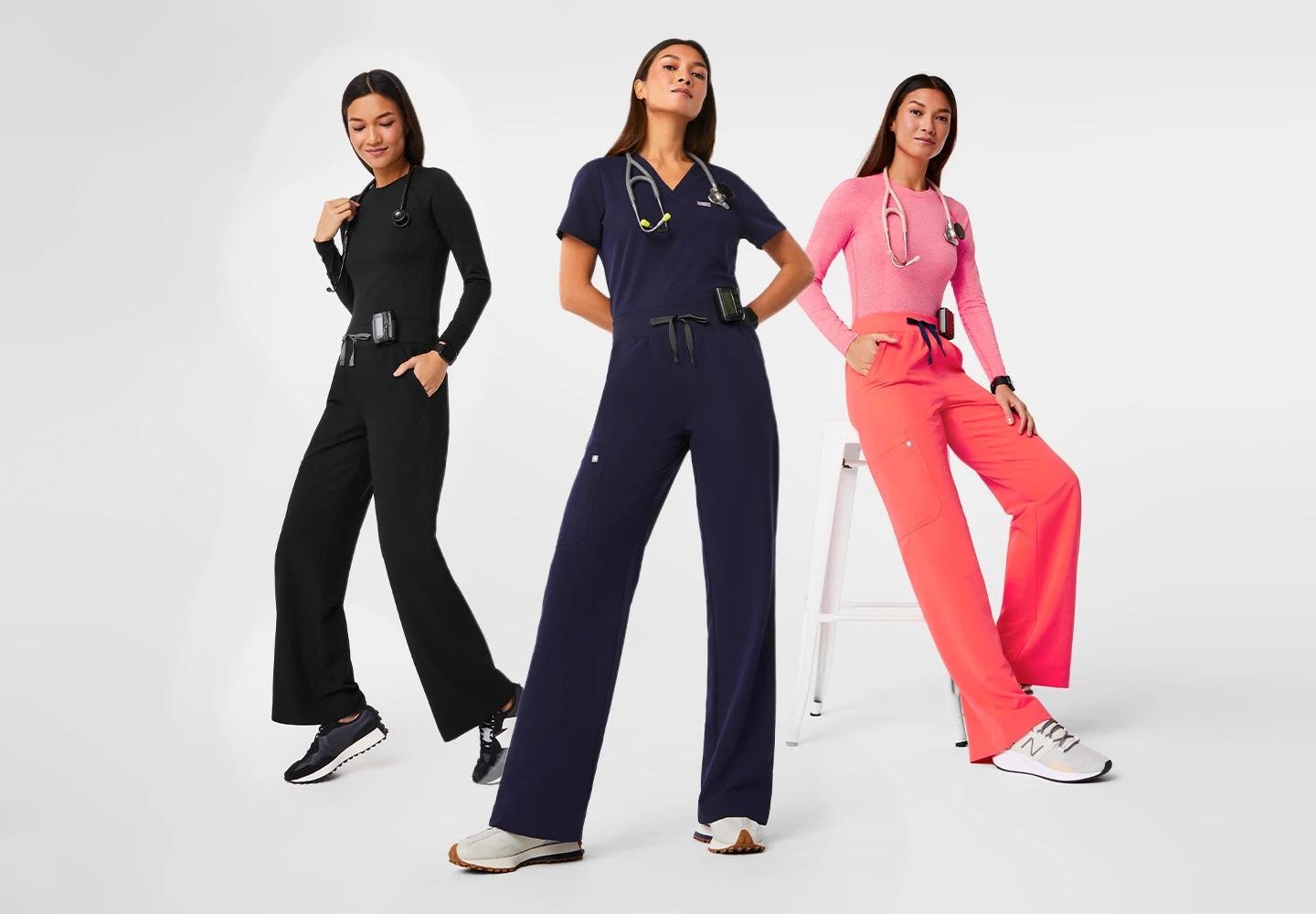 3 women posing in FIGS scrubs