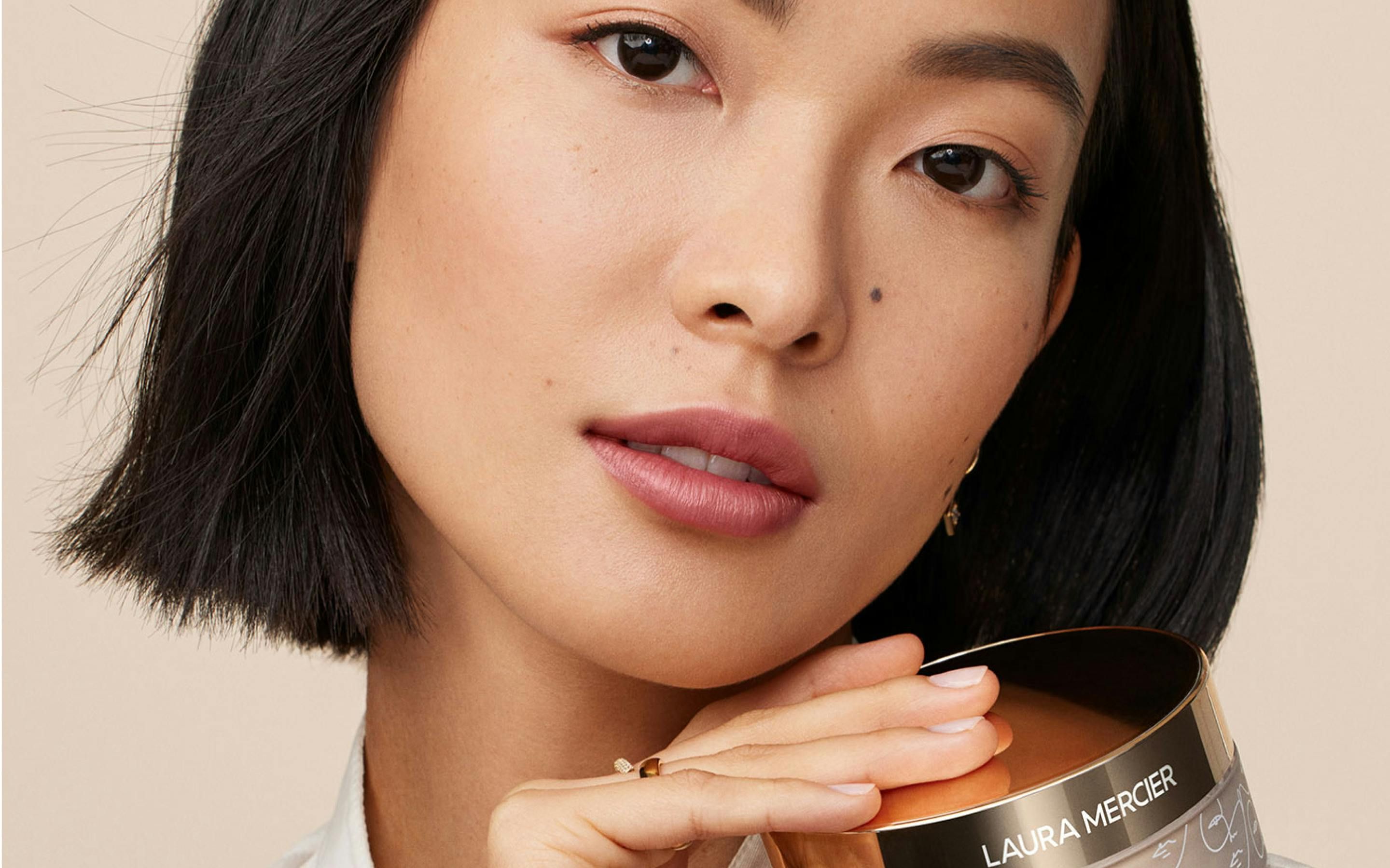 Woman posing with Laura Mercier product