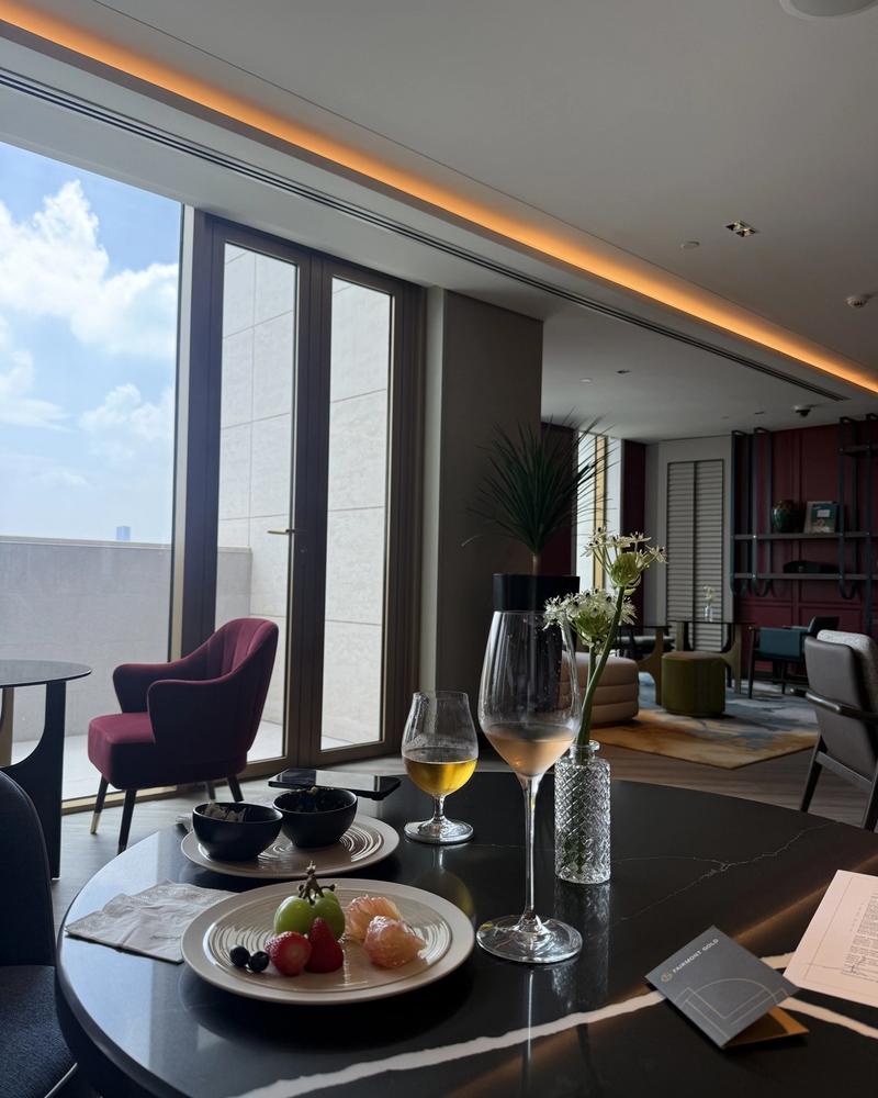 A glass of wine by the window over the city