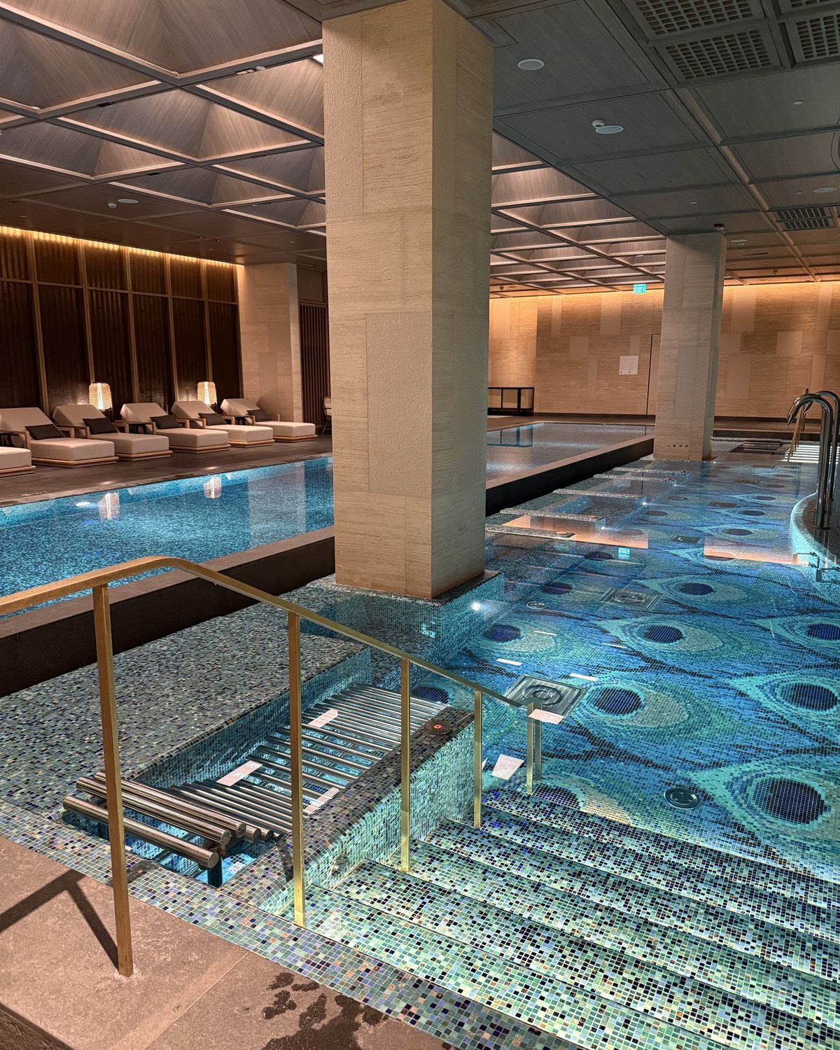 The indoor pool lined with blue mosaic