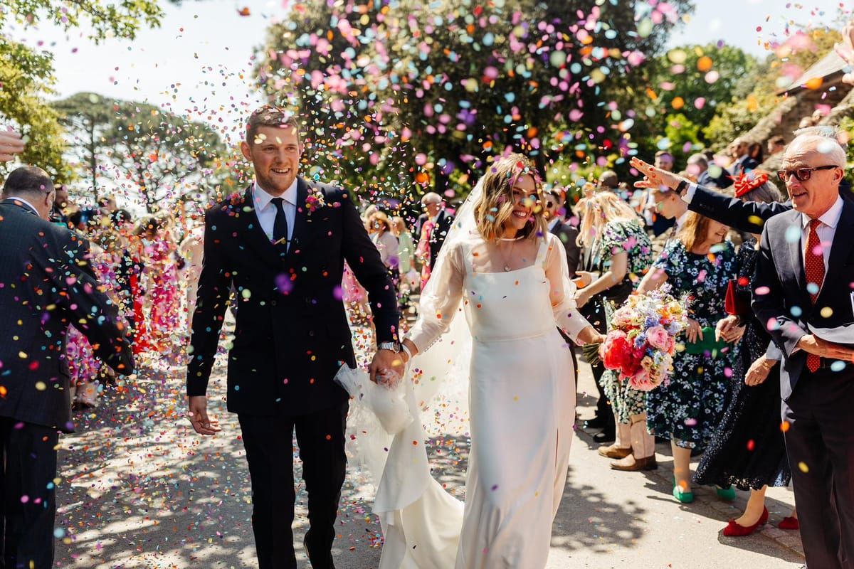 Wedding ceremony confetti celebration with bride and groom